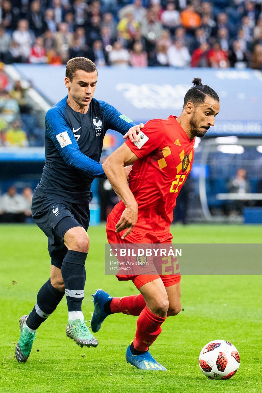 Antoine Griezmann of France competes for the ball with Nacer Chadli of Belgium during the FIFA World Cup semi final match between France and Belgium on July 10, 2018 in ST Petersburg.