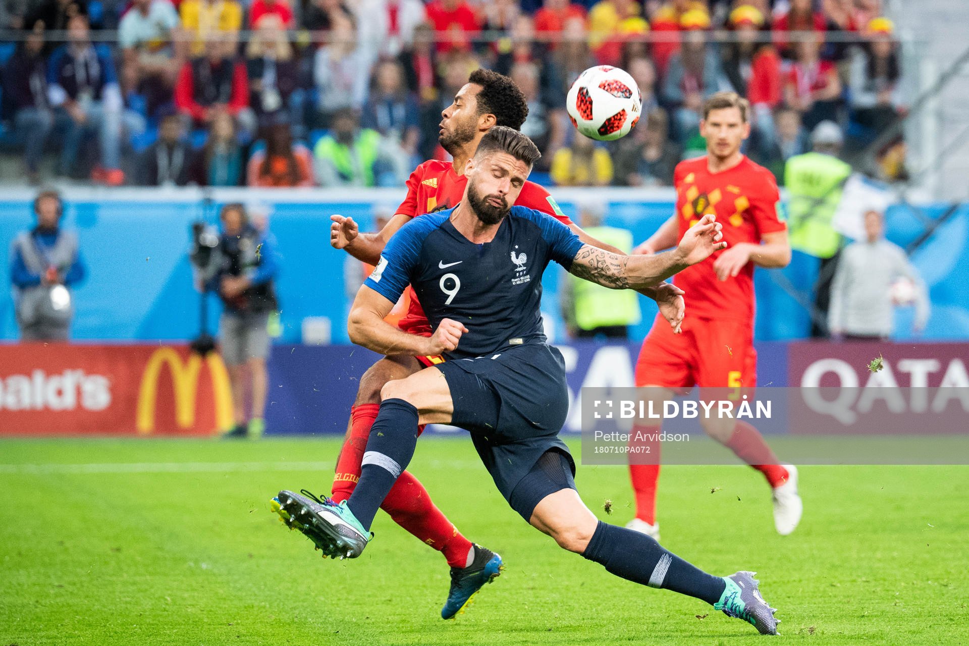 Olivier Giroud of France competes for the ball with Moussa
