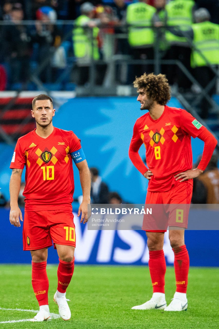 Eden Hazard and Marouane Fellaini of Belgium look dejected