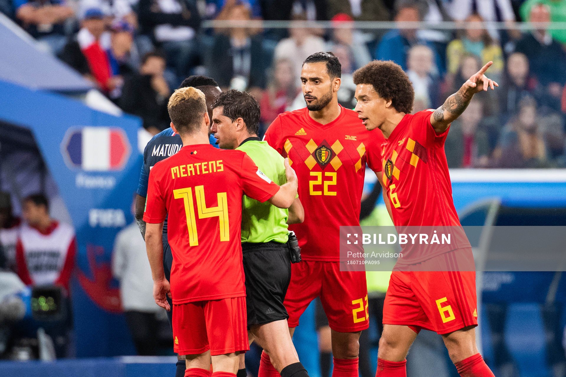 Dries Mertens, Nacer Chadli and Axel Witsel of Belgium react towards referee Andres Cunhaduring the FIFA World Cup semi final match between France and Belgium on July 10, 2018 in ST Petersburg.