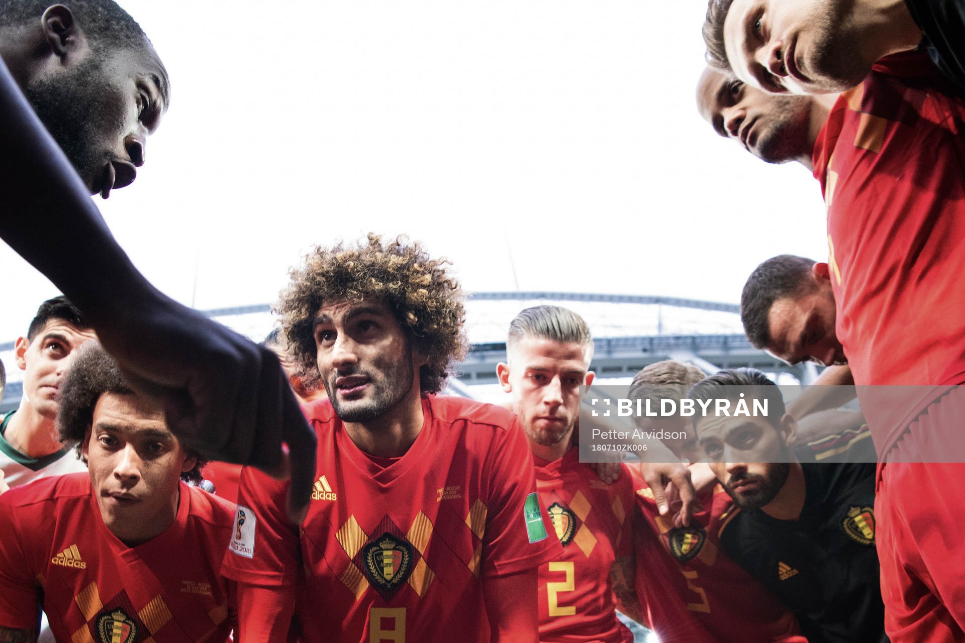 Romelu Lukaku talks to team mates Axel Witsel, Marouane