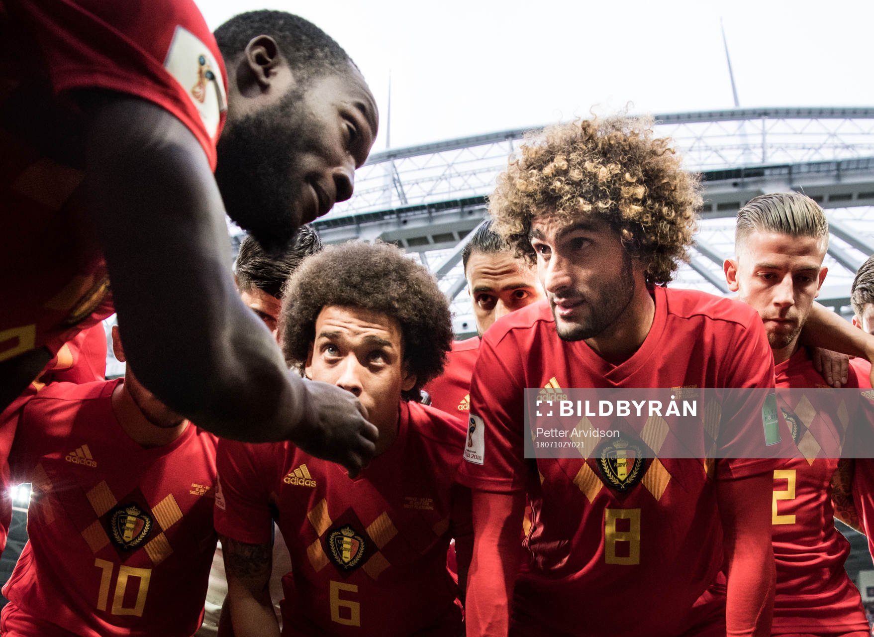 Romelu Lukaku talks to team mates Axel Witsel and Marouane