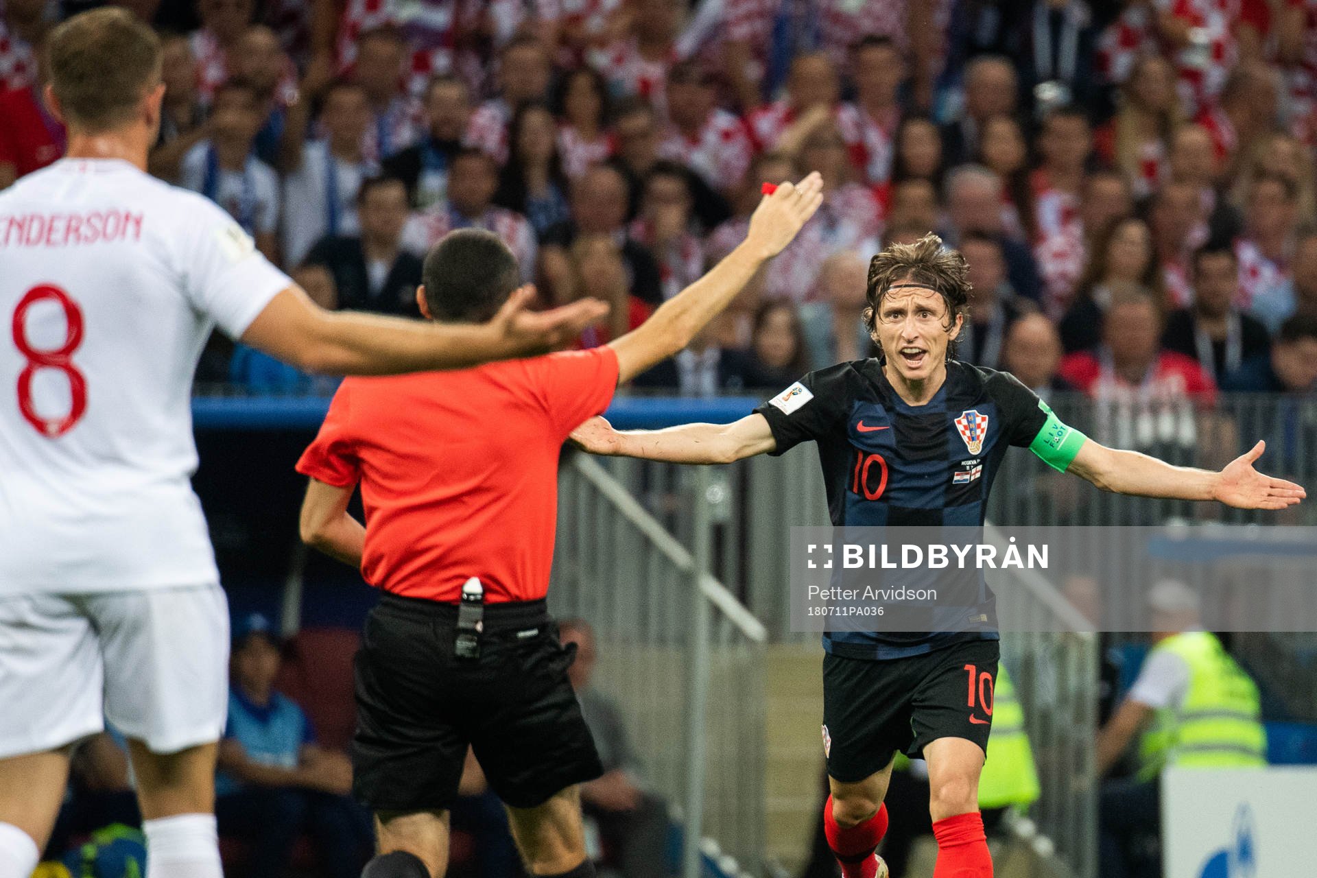 Luka Modric of Croatia react toward referee Cuneyt Cakir