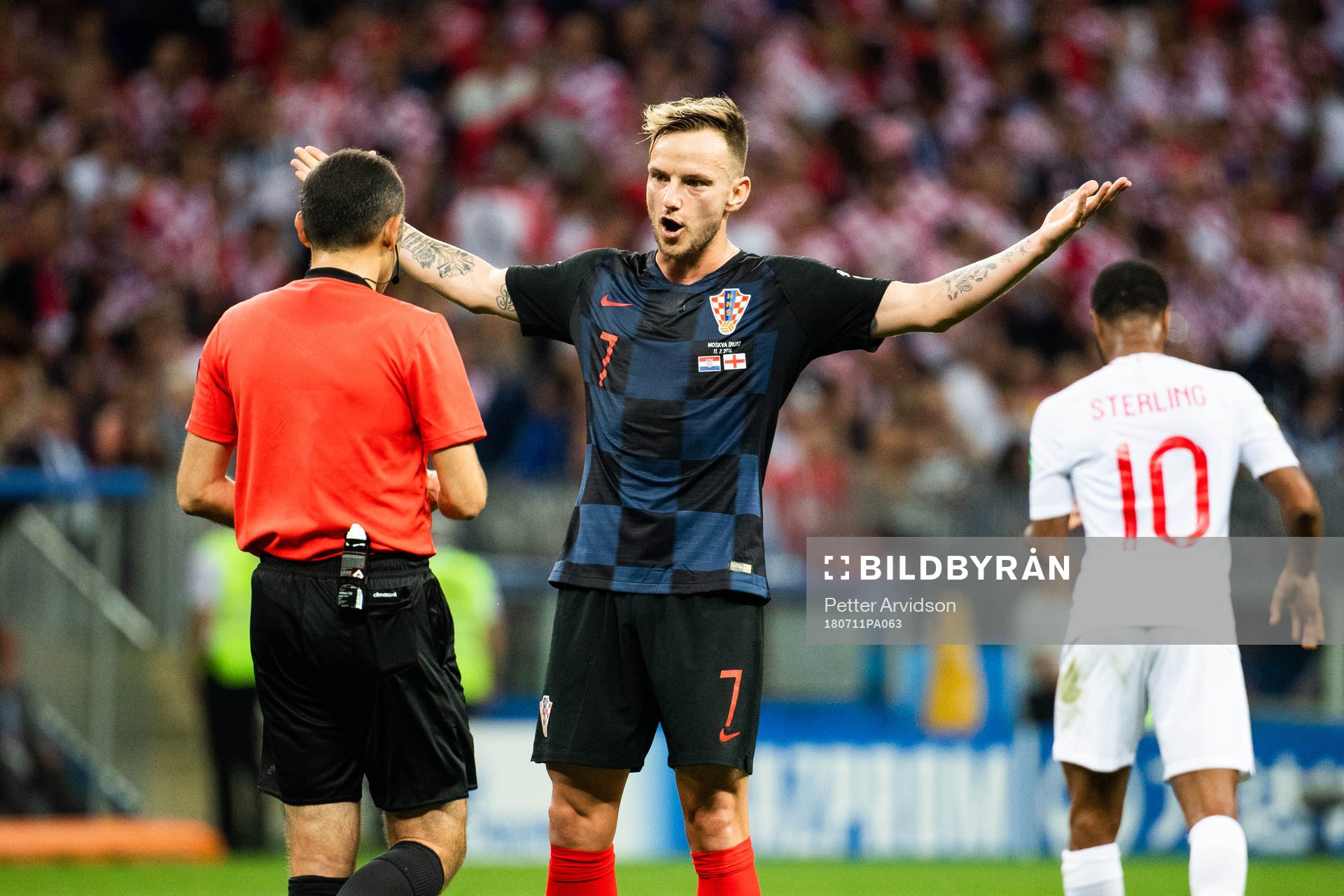 Ivan Rakitic of Croatia in a discussion with referee Cuneyt