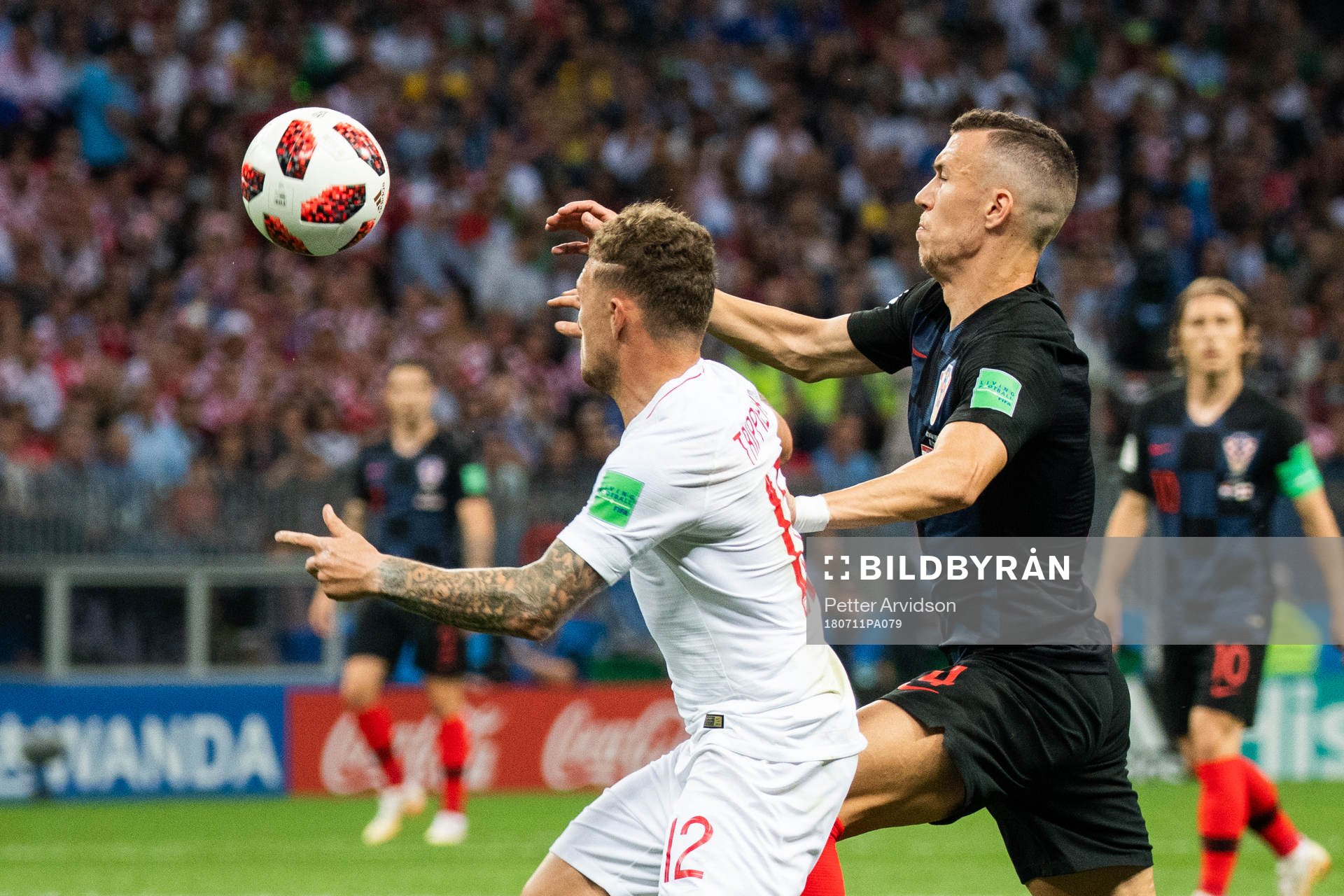 Kieran Trippier of England competes for the ball with Ivan