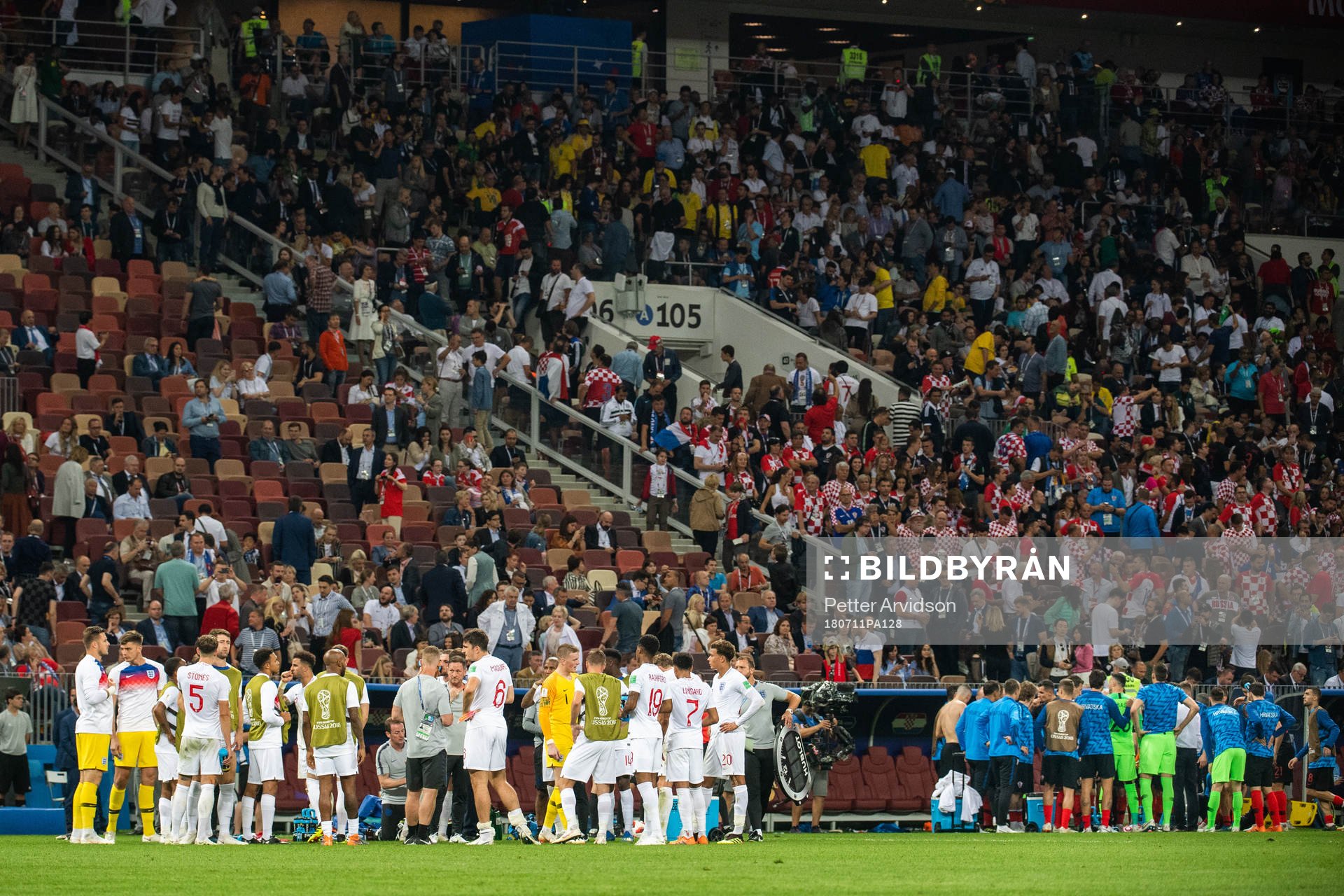 Players of England and of Croatia gather in wait for extra