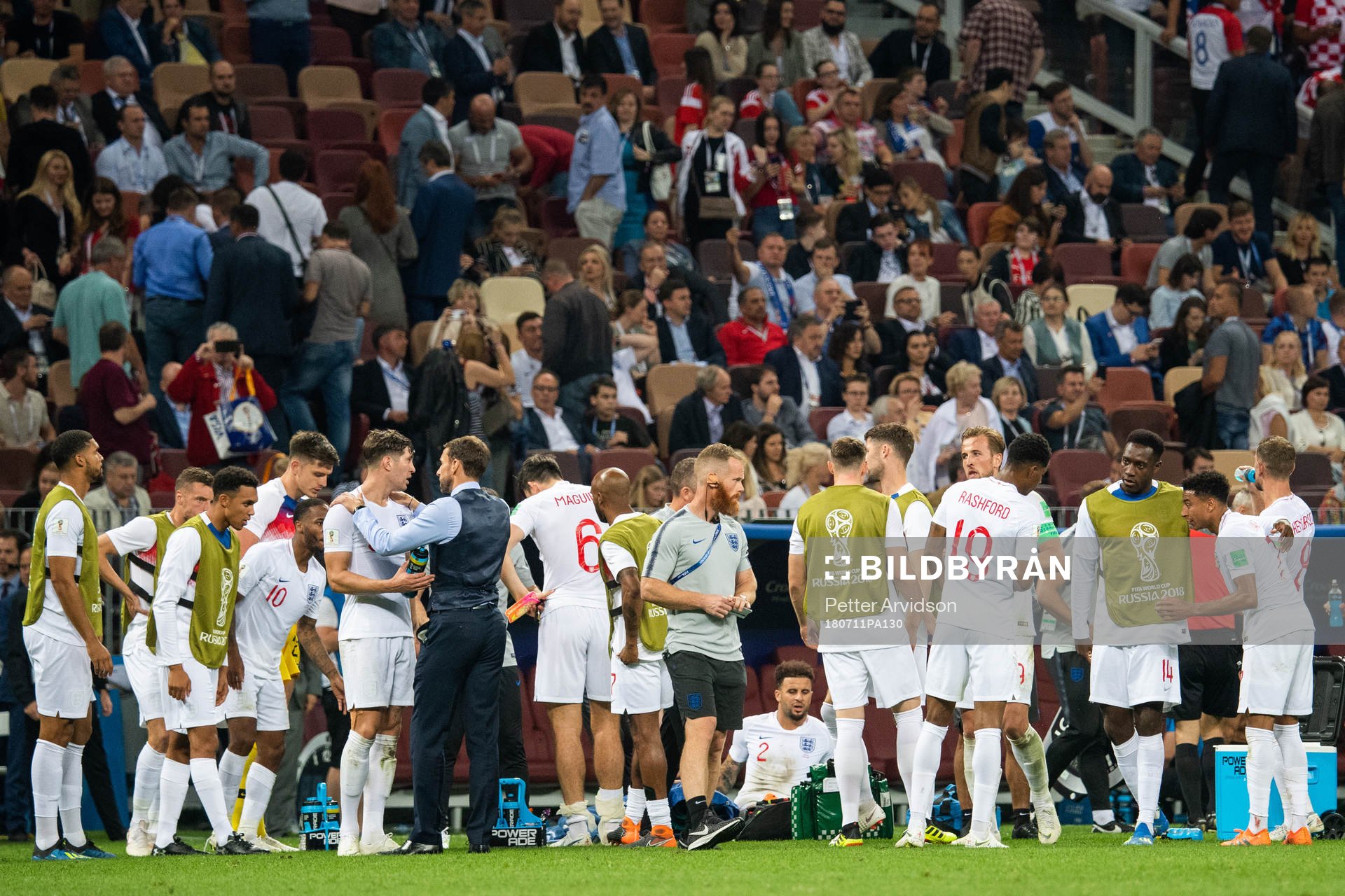 Players of England gather in wait for extra time