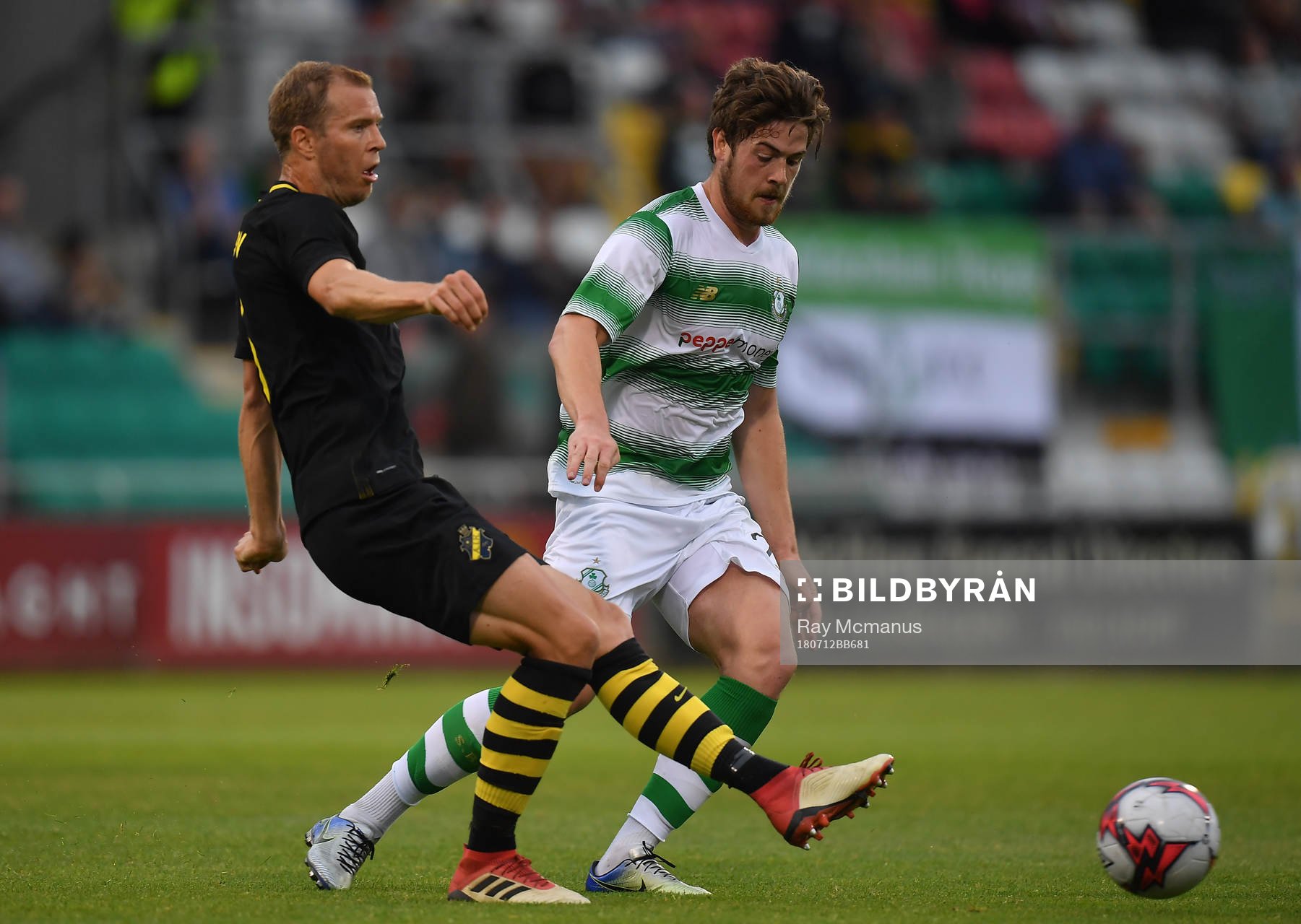 Per Karlsson of AIK in action against Sam Bone of Shamrock