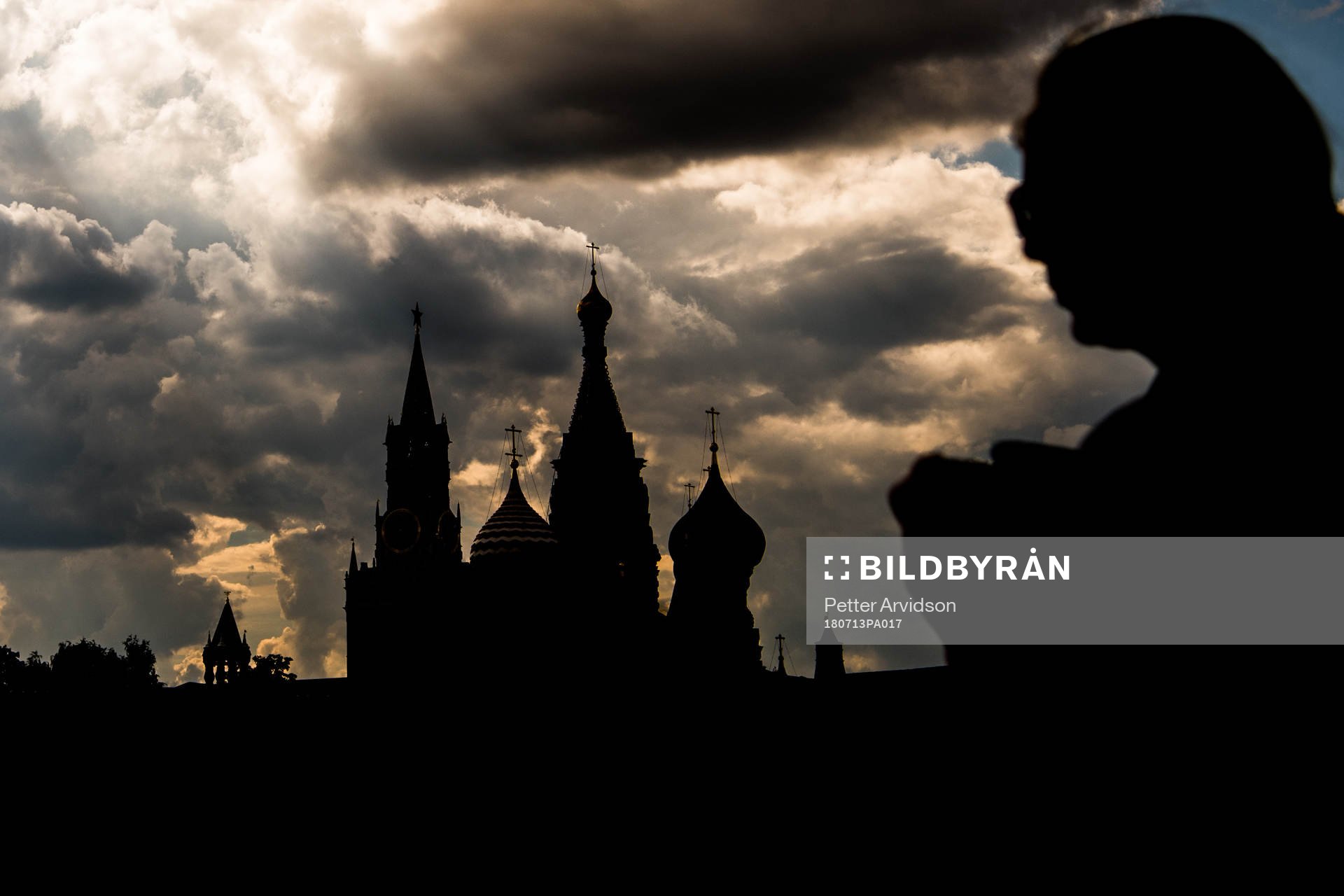 People walk by the Saint Basil's Cathedral
