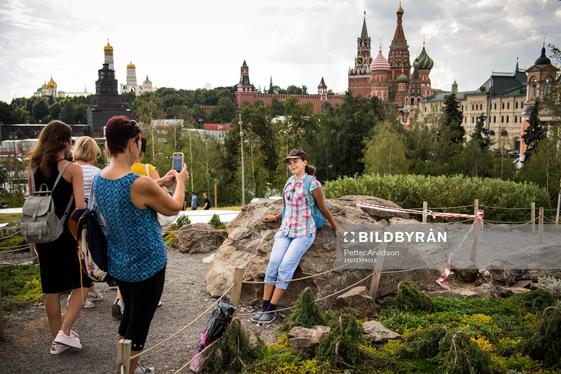 People take pictures with the Saint Basil's Cathedral in