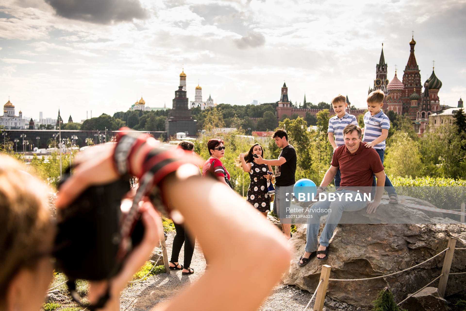 People take pictures with the Saint Basil's Cathedral in