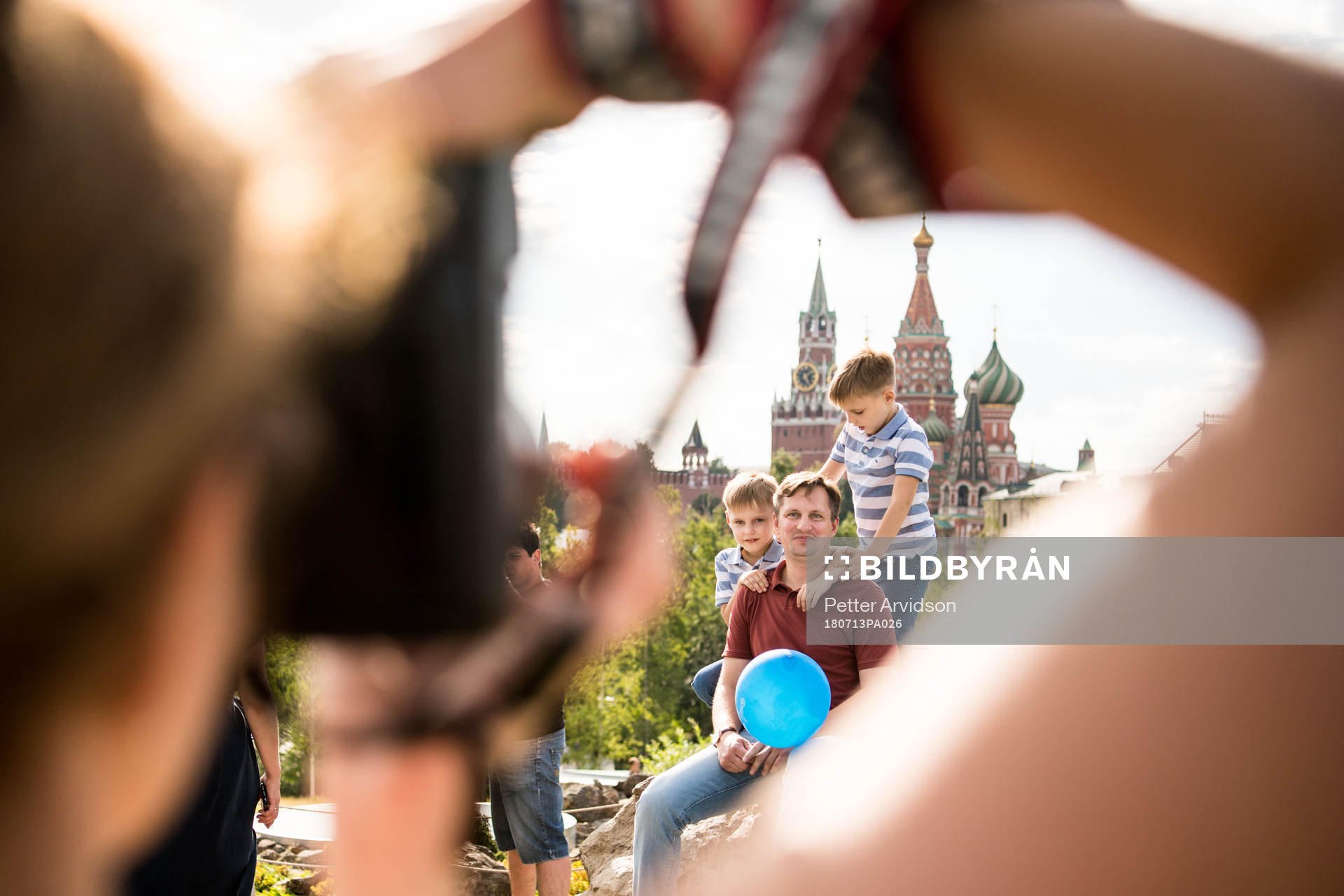 People take pictures with the Saint Basil's Cathedral in