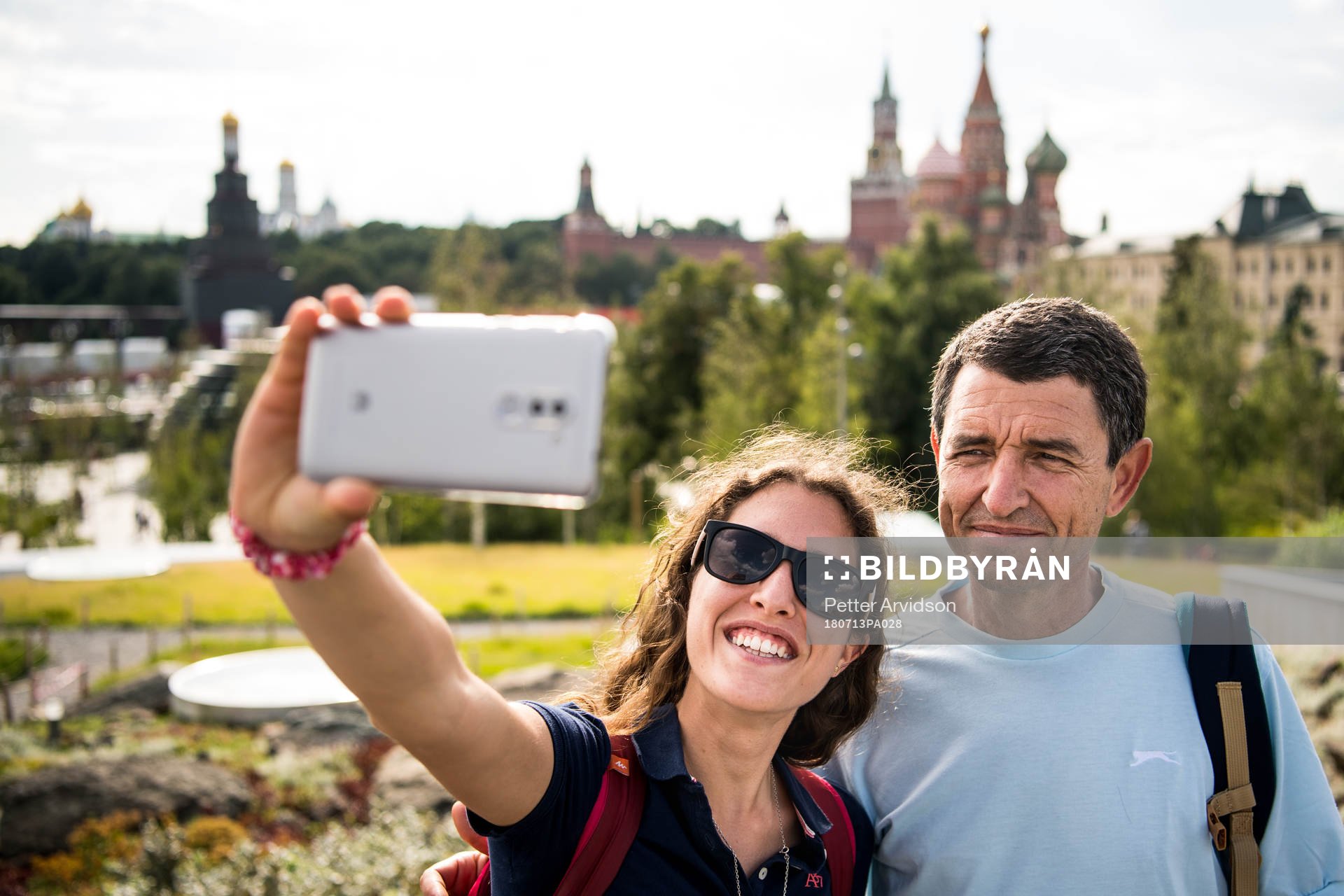 People take pictures with the Saint Basil's Cathedral in