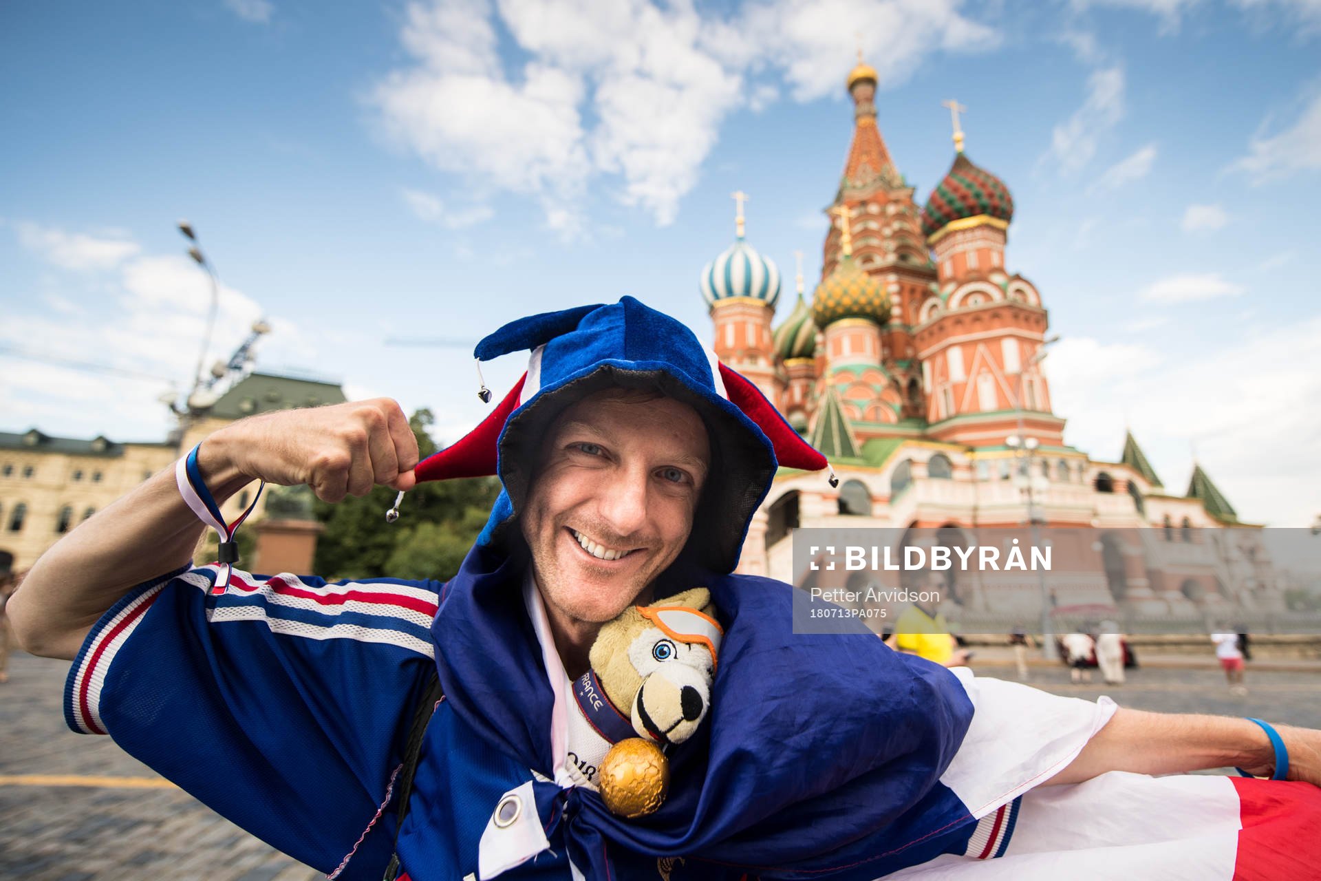 A fan of France in front of Saint Basil's Cathedral at the