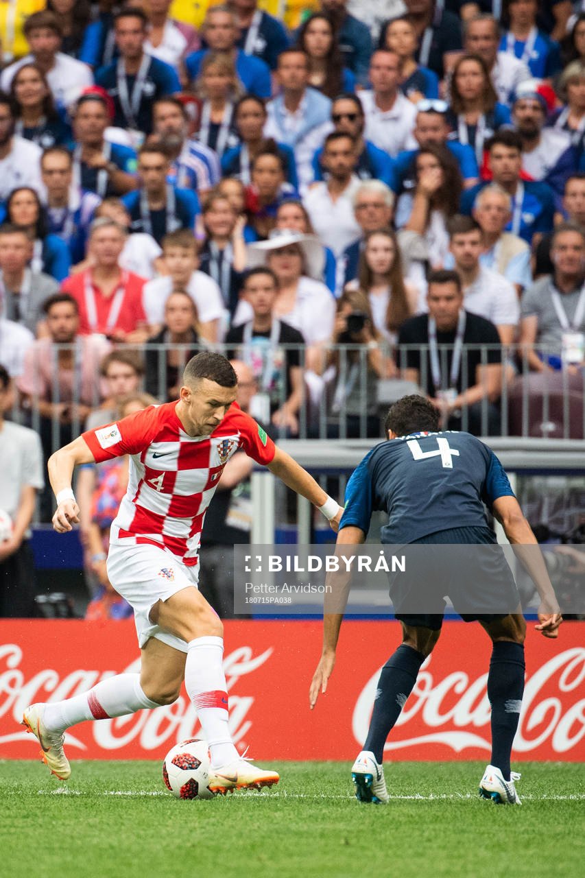 Ivan Perisic of Croatia challenges Raphael Varane of France