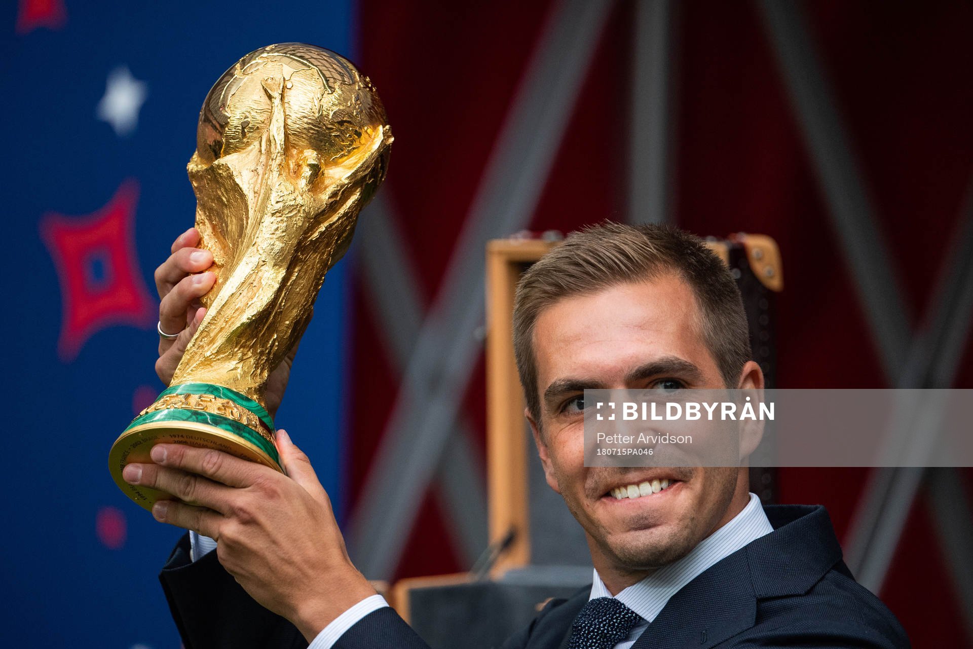 Philipp Lahm brings the World Cup Trophy in to the stadium