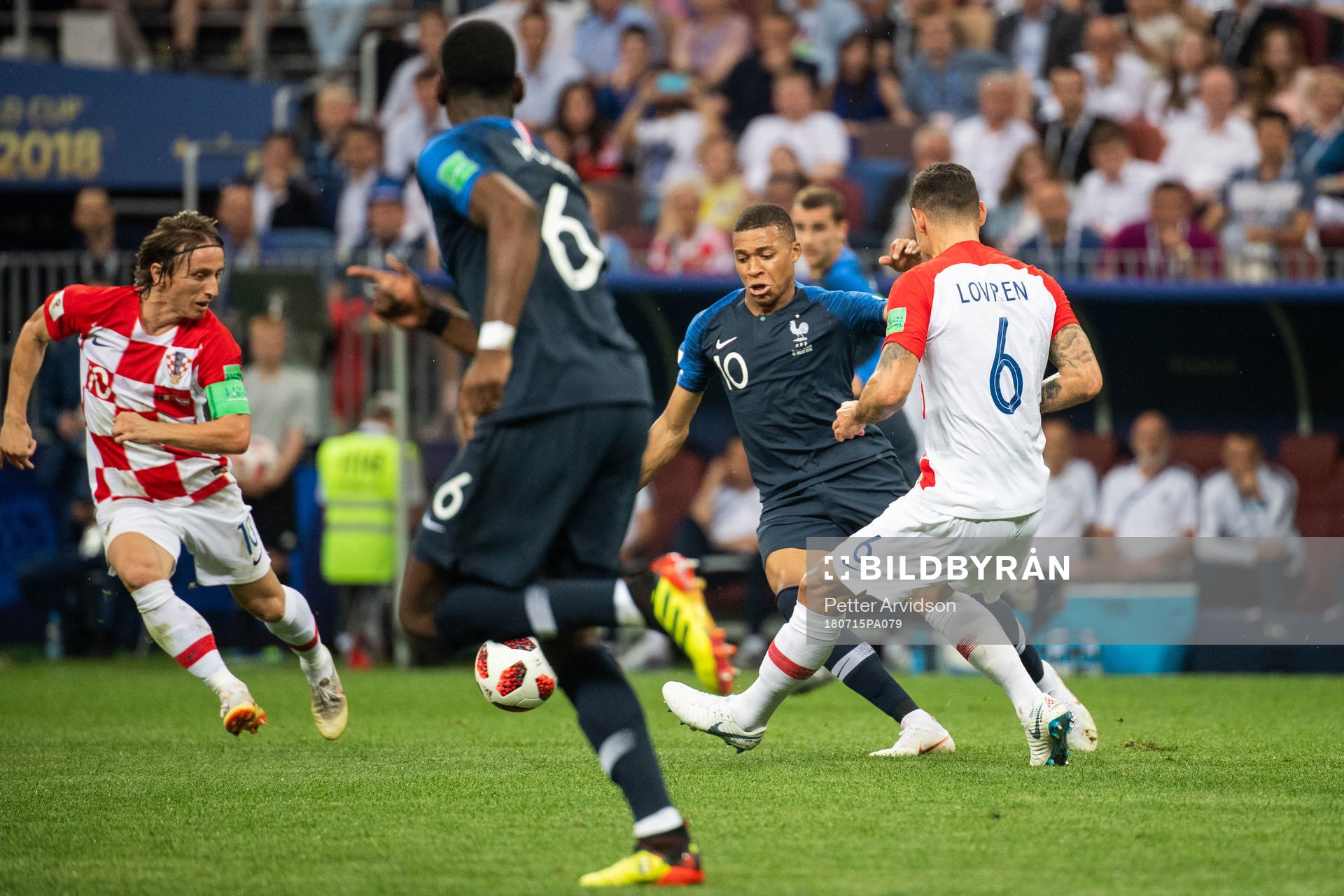 Kylian Mbappe of France competes for the ball with Dejan