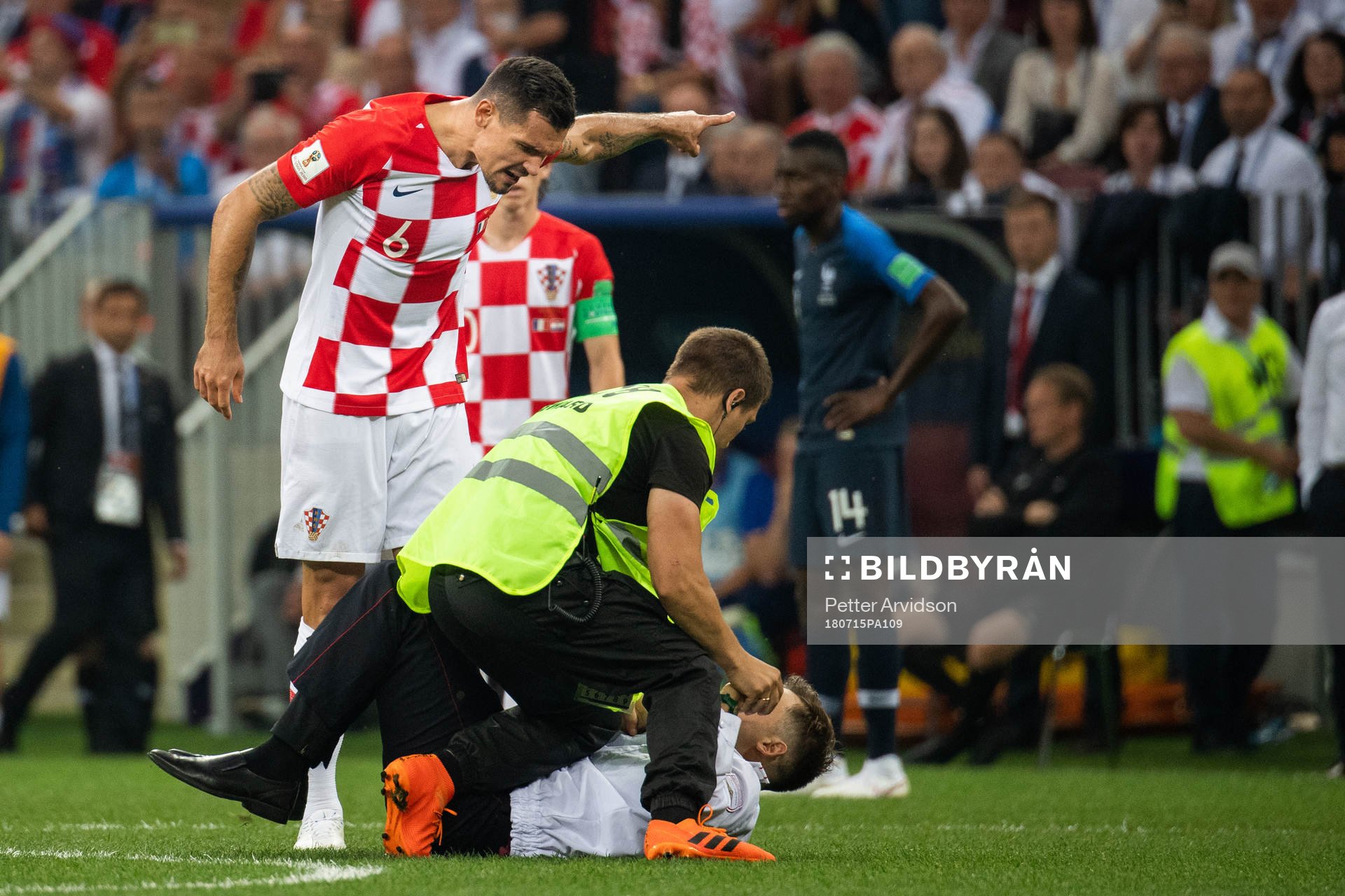 Dejan Lovren of Croatia and a steward in a situation with
