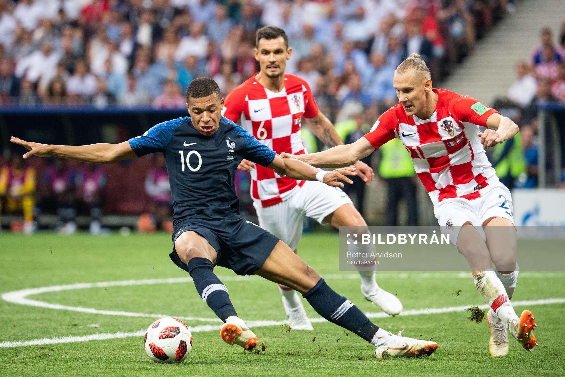 Kylian Mbappe of France competes for the ball with Domagoj