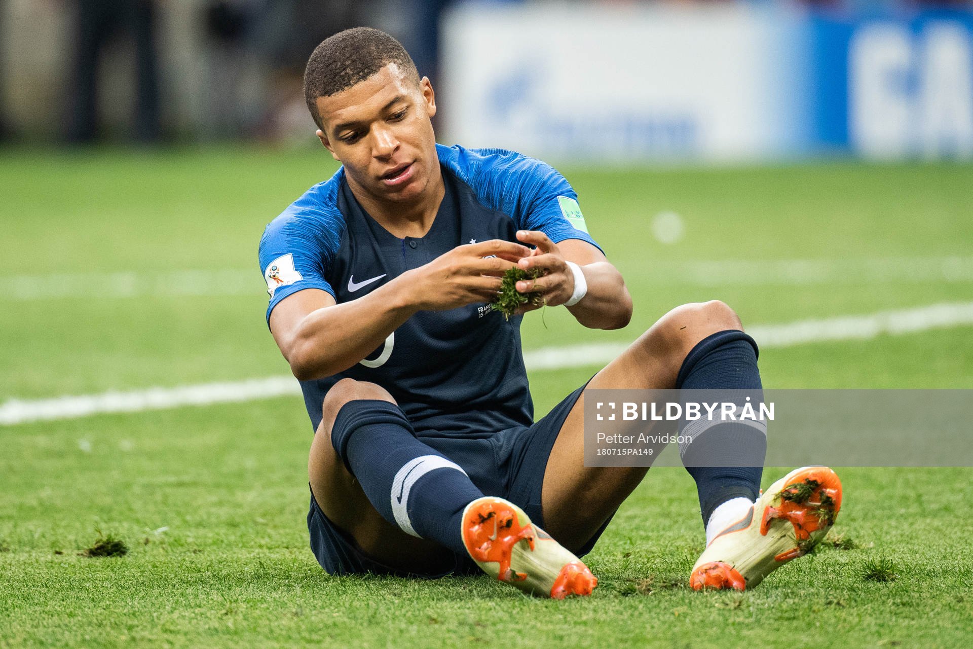 Kylian Mbappe of France with a piece of grass in his hands