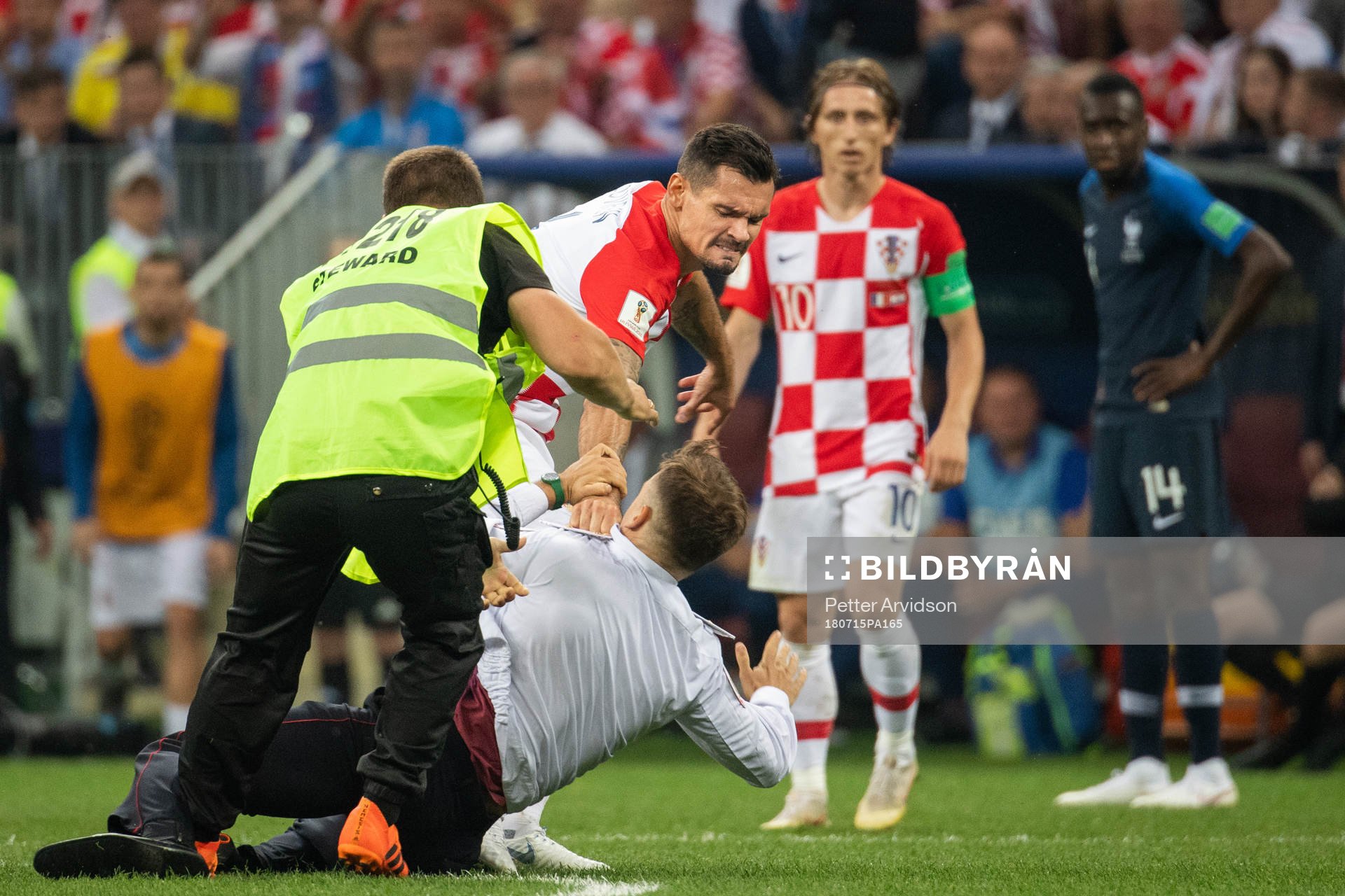 Dejan Lovren of Croatia reacts against a pitch invader