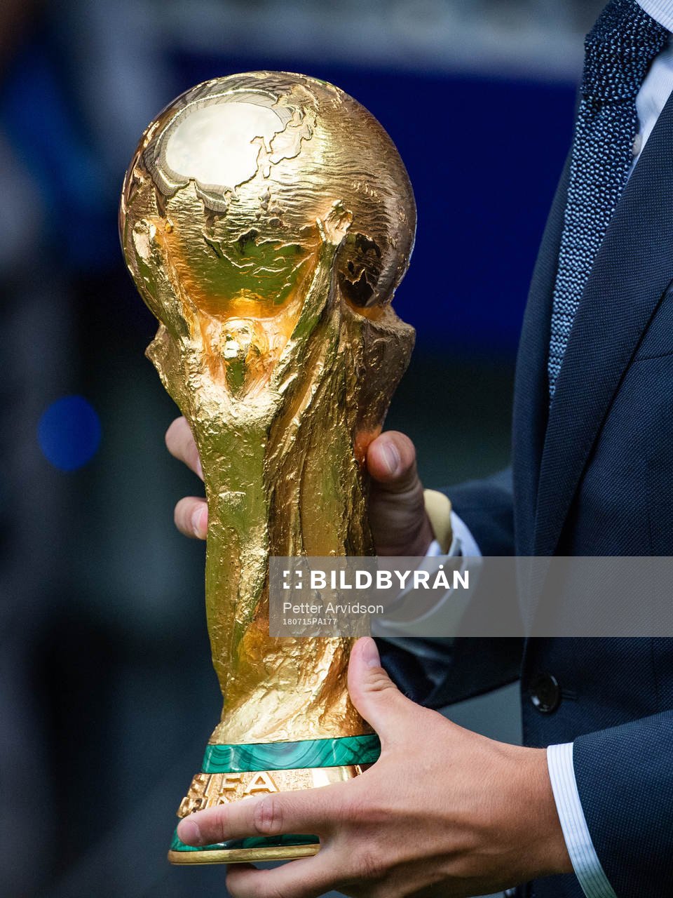 Philipp Lahm brings the World Cup Trophy in to the stadium