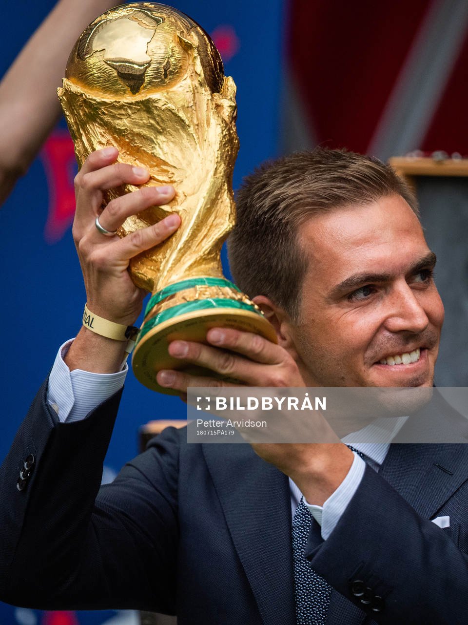 Philipp Lahm brings the World Cup Trophy in to the stadium