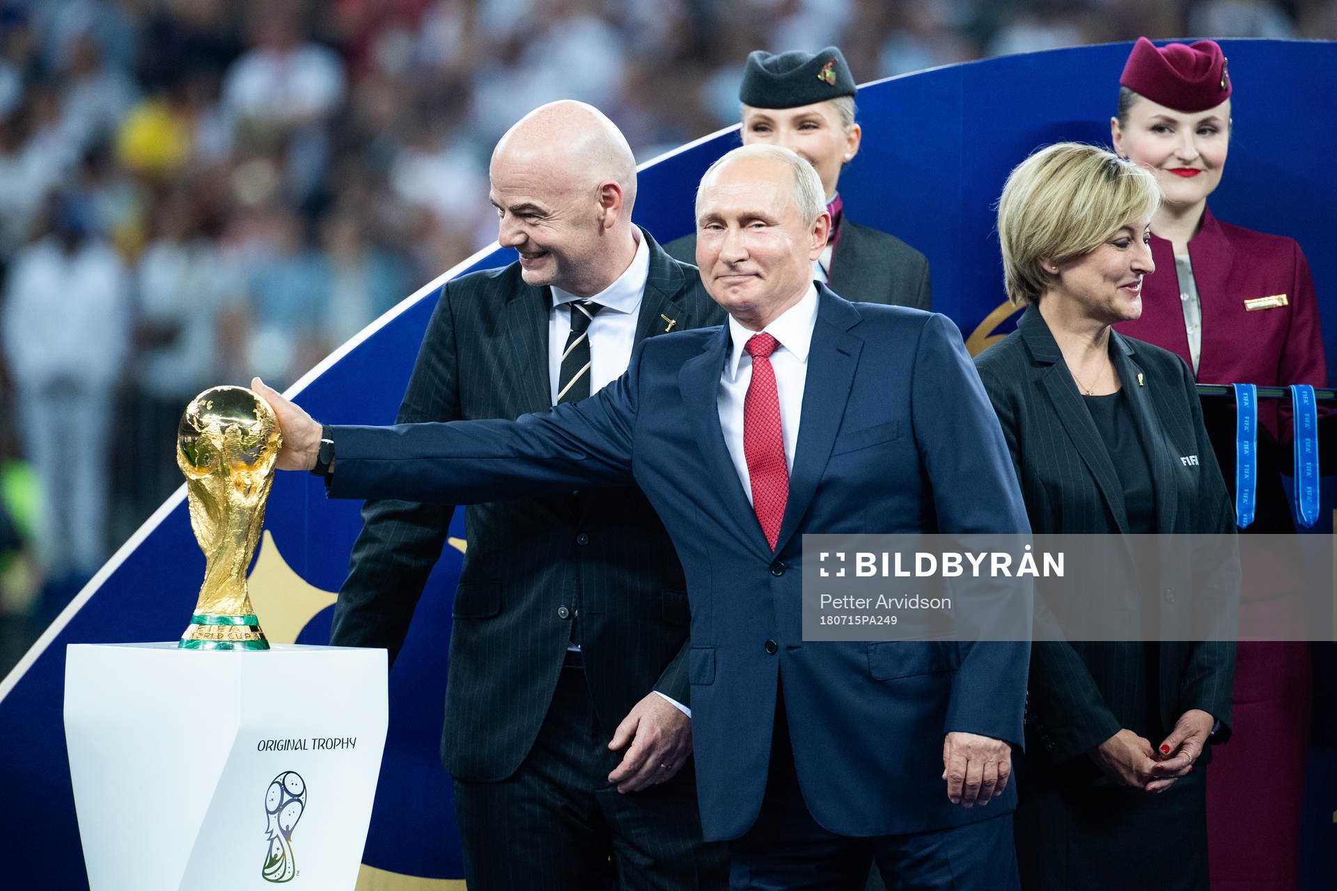 Vladimir Putin, president of Russia with his hand on the trophy at the price ceremony after the FIFA World Cup final match between France and Croatia on July 15, 2018 in Moscow.