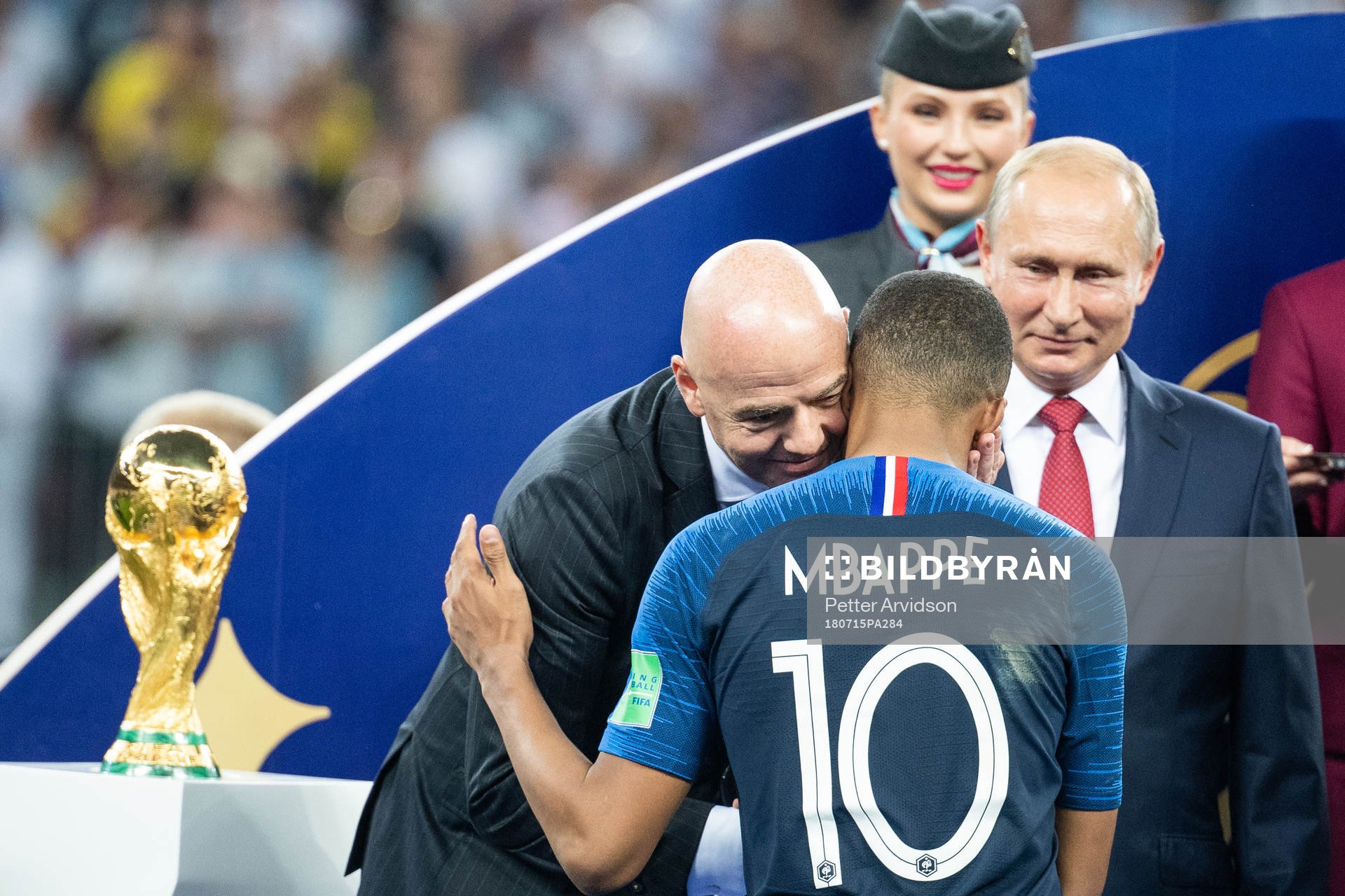 FIFA president Gianni Infantino hugs Kylian Mbappe of France