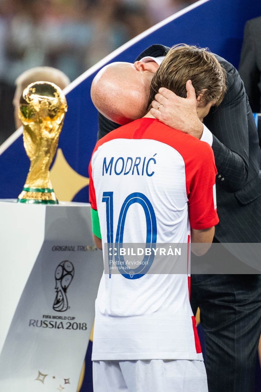 FIFA president Gianni Infantino hugs Luka Modric of Croatia