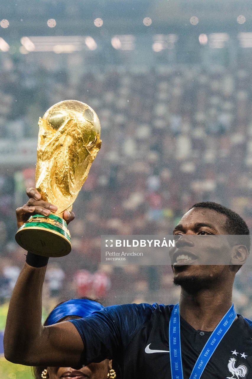 Paul Pogba of France with the trophy while celebrating