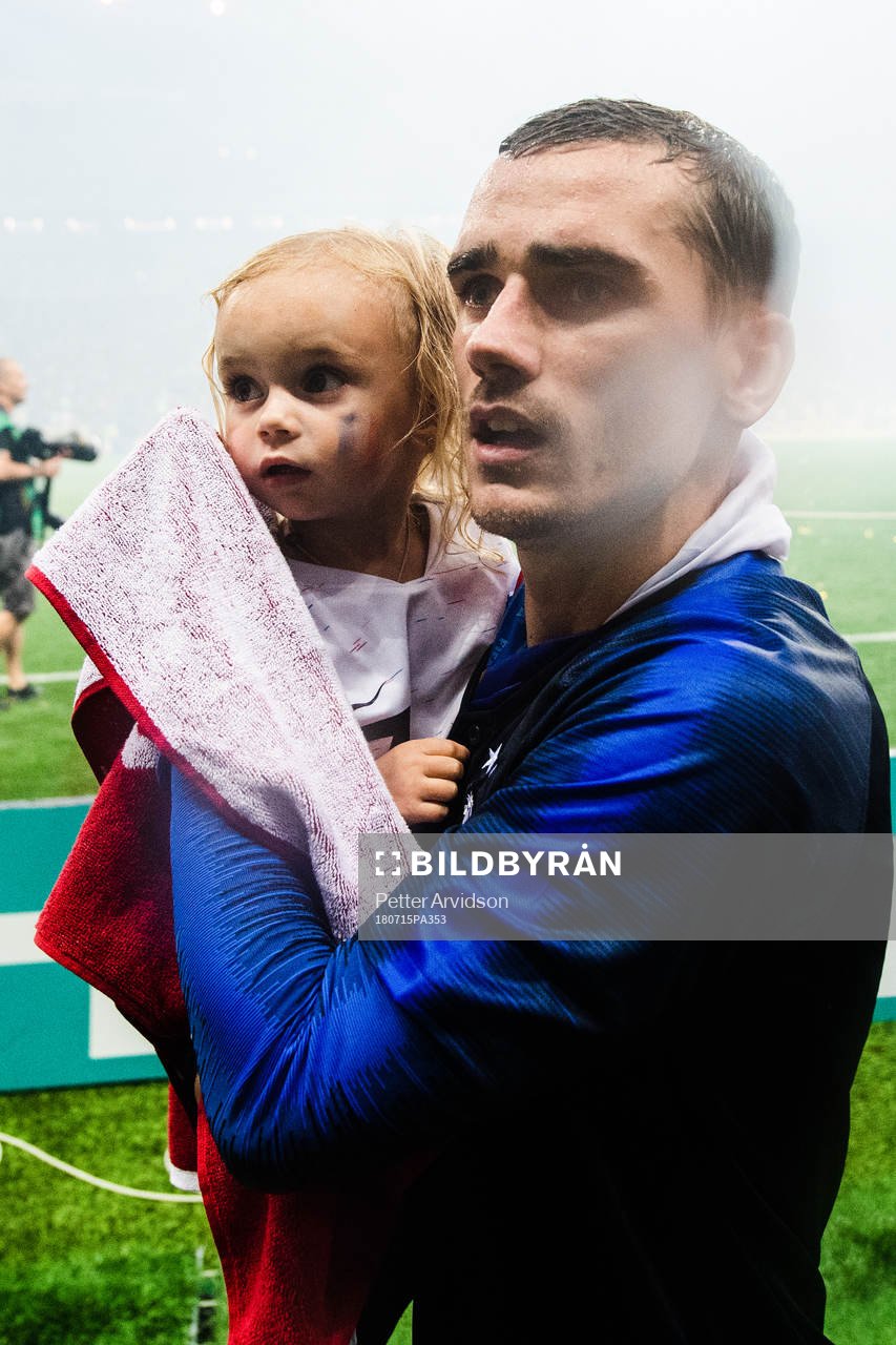 Antoine Griezmann of France celebrates together with a child