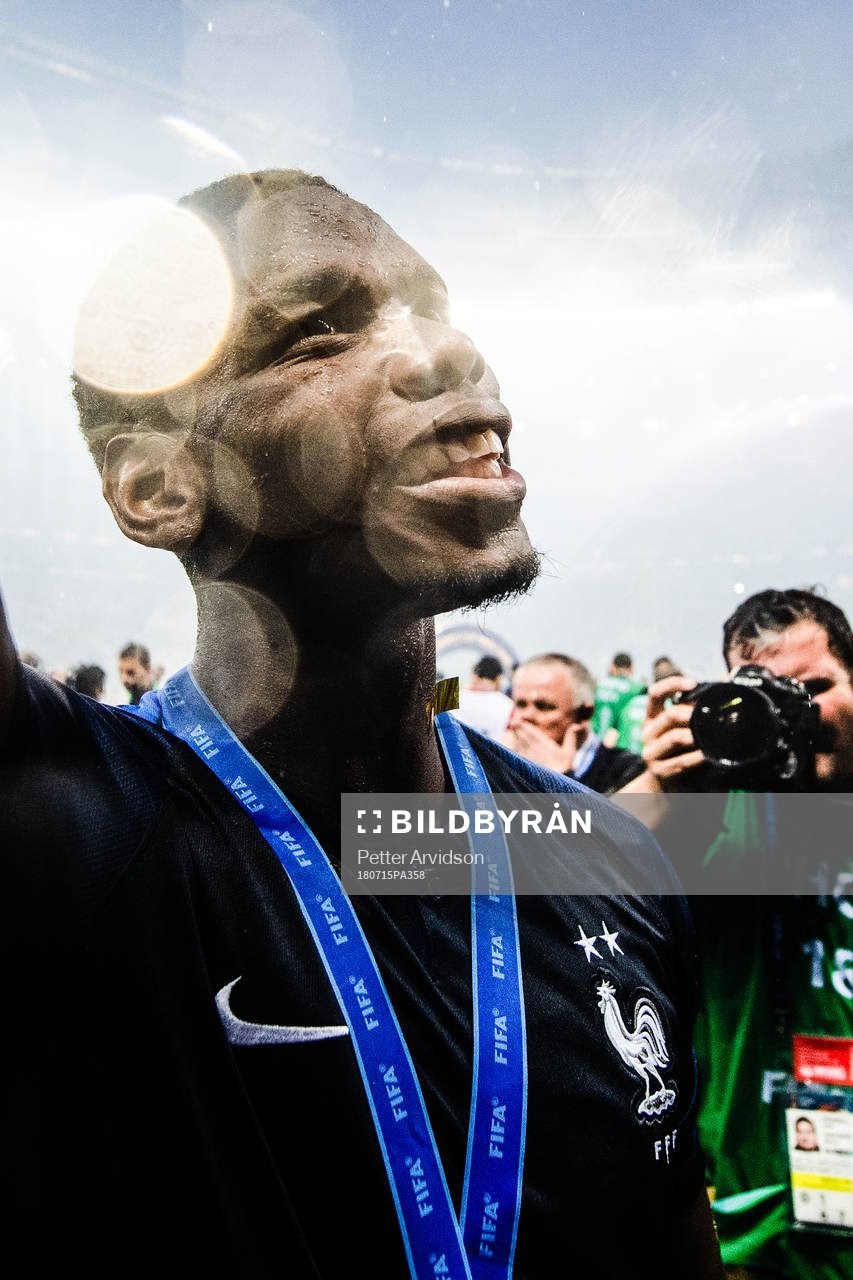 Paul Pogba of France celebrates with the gold medal around