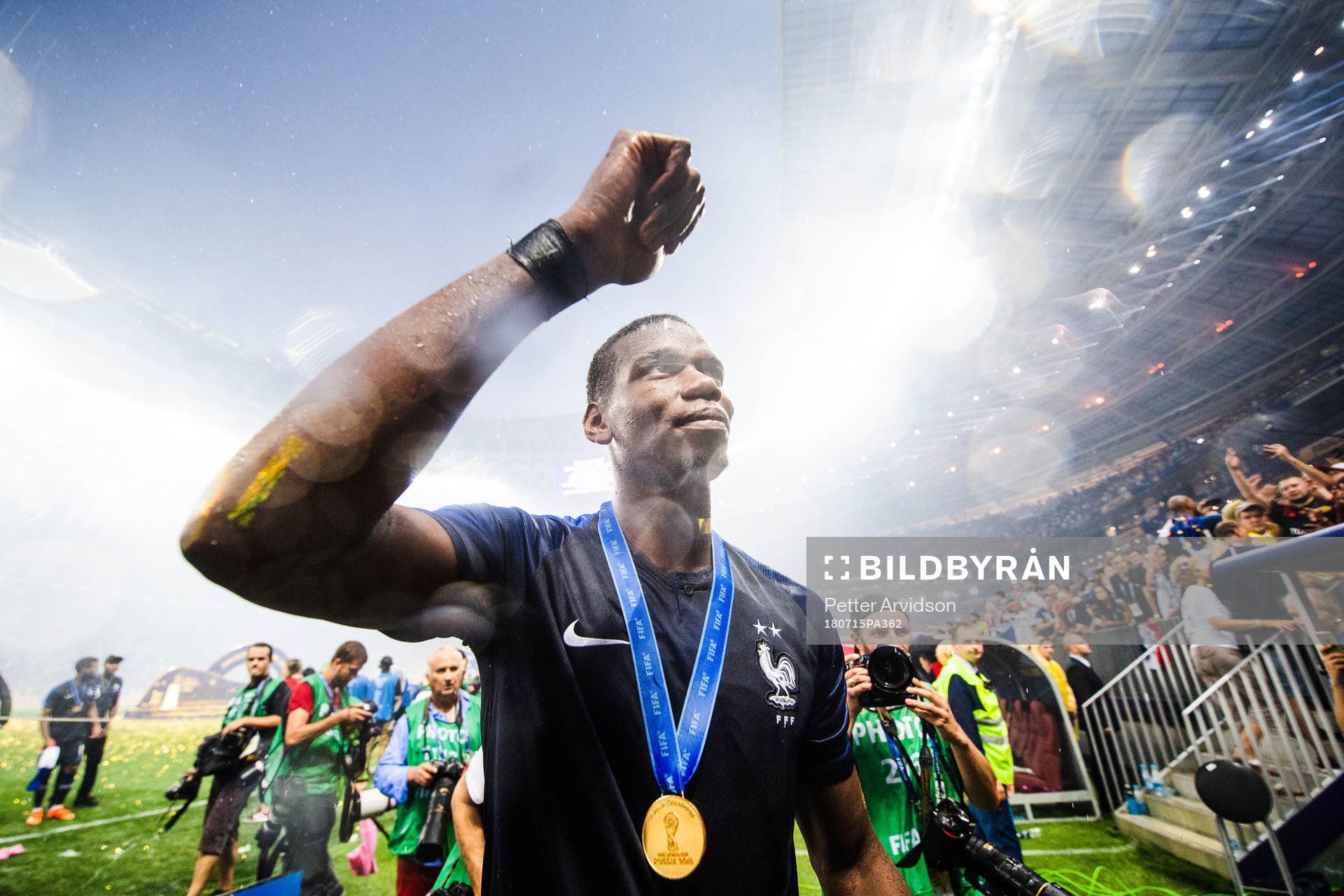Paul Pogba of France celebrates with the gold medal around