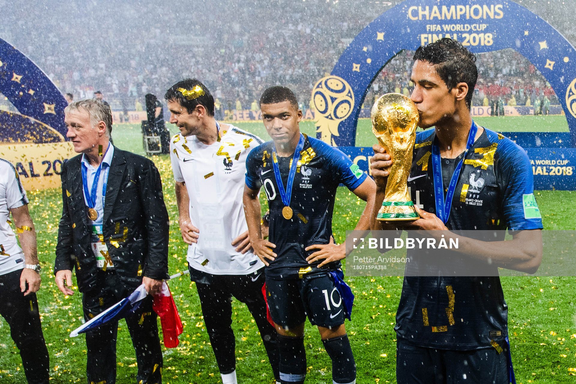 Raphael Varane of France celebrates with kissing the trophy