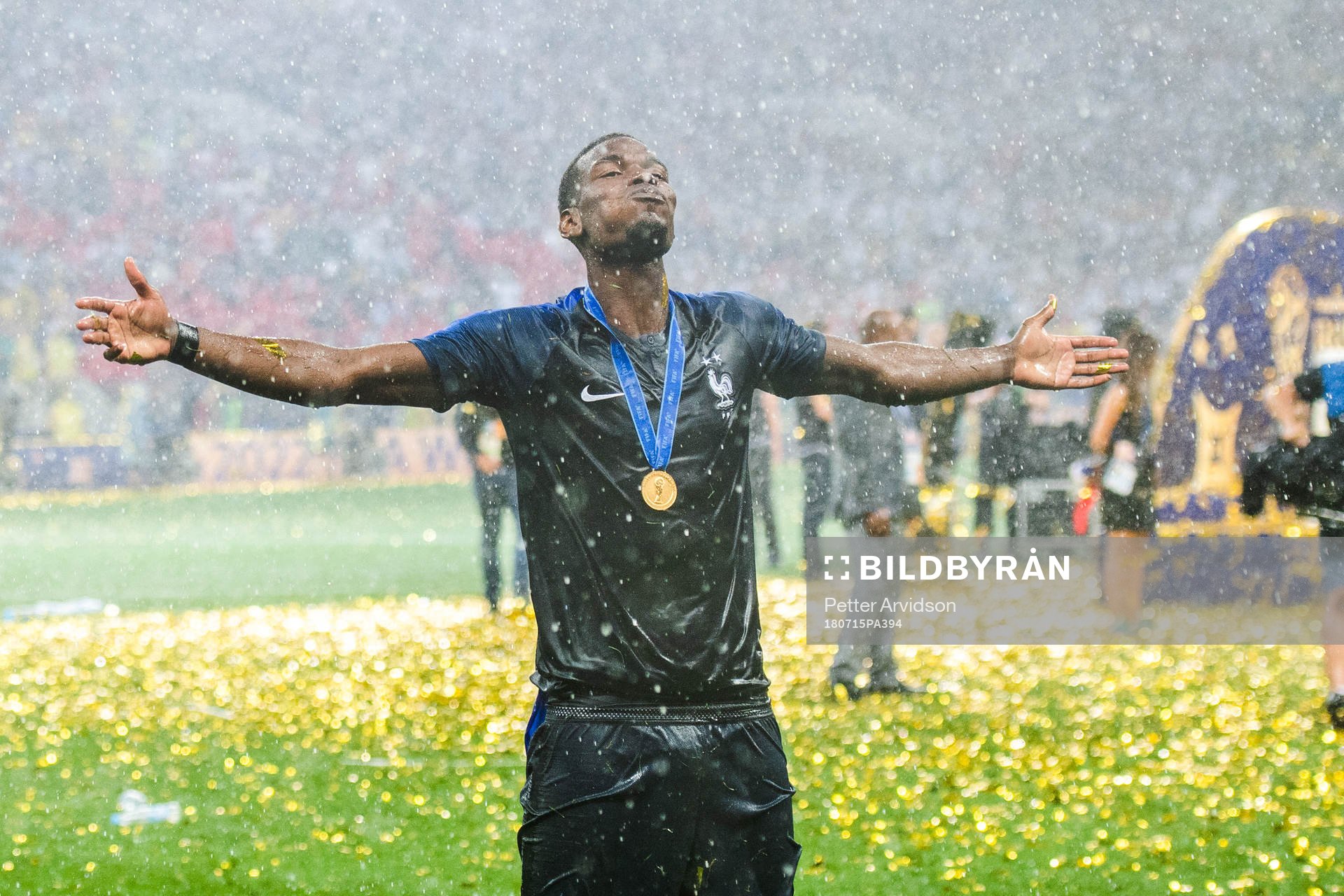 Paul Pogba of France celebrates with the gold medal around