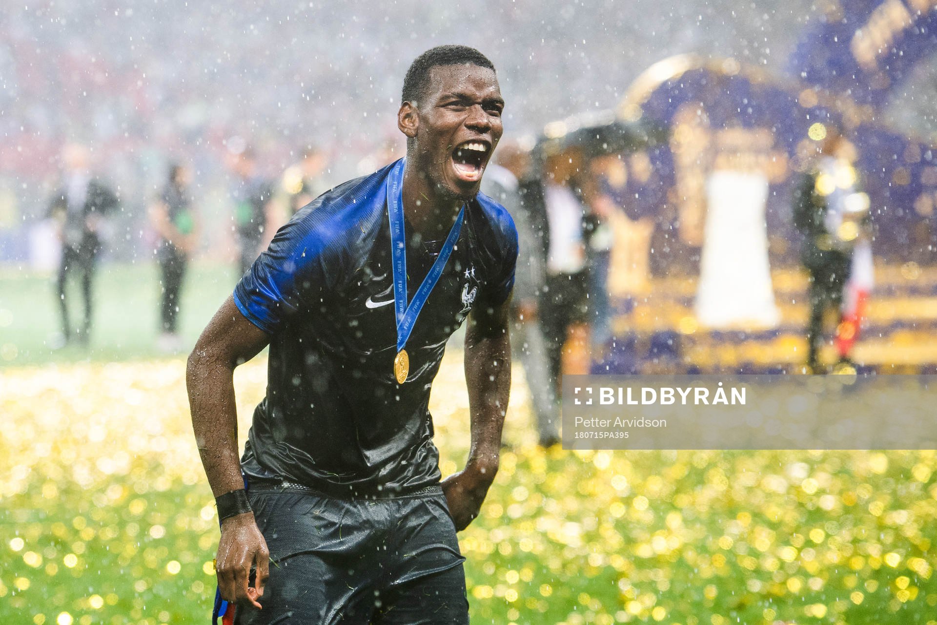 Paul Pogba of France celebrates with the gold medal around