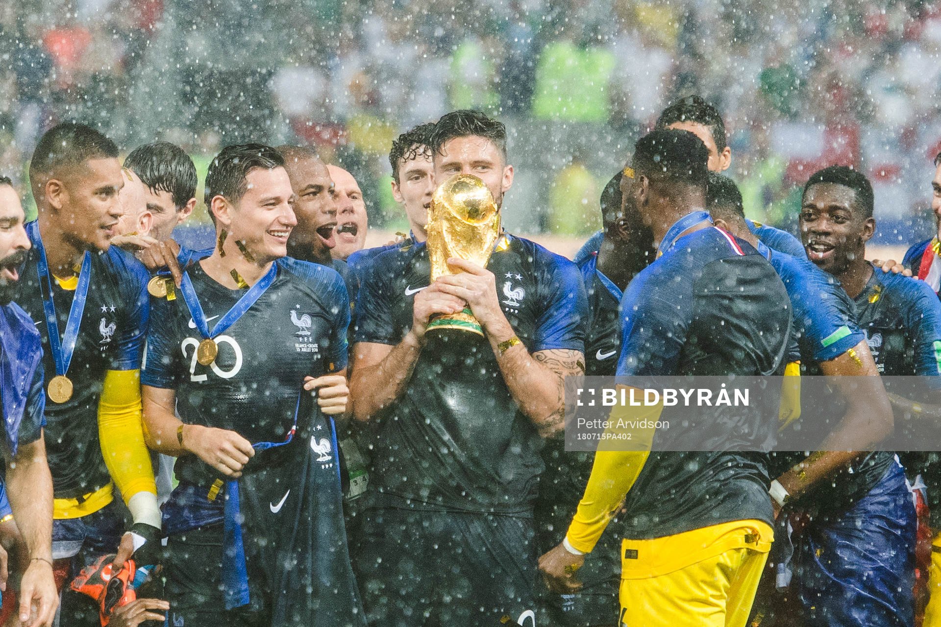 Olivier Giroud of France kisses the trophy while he and