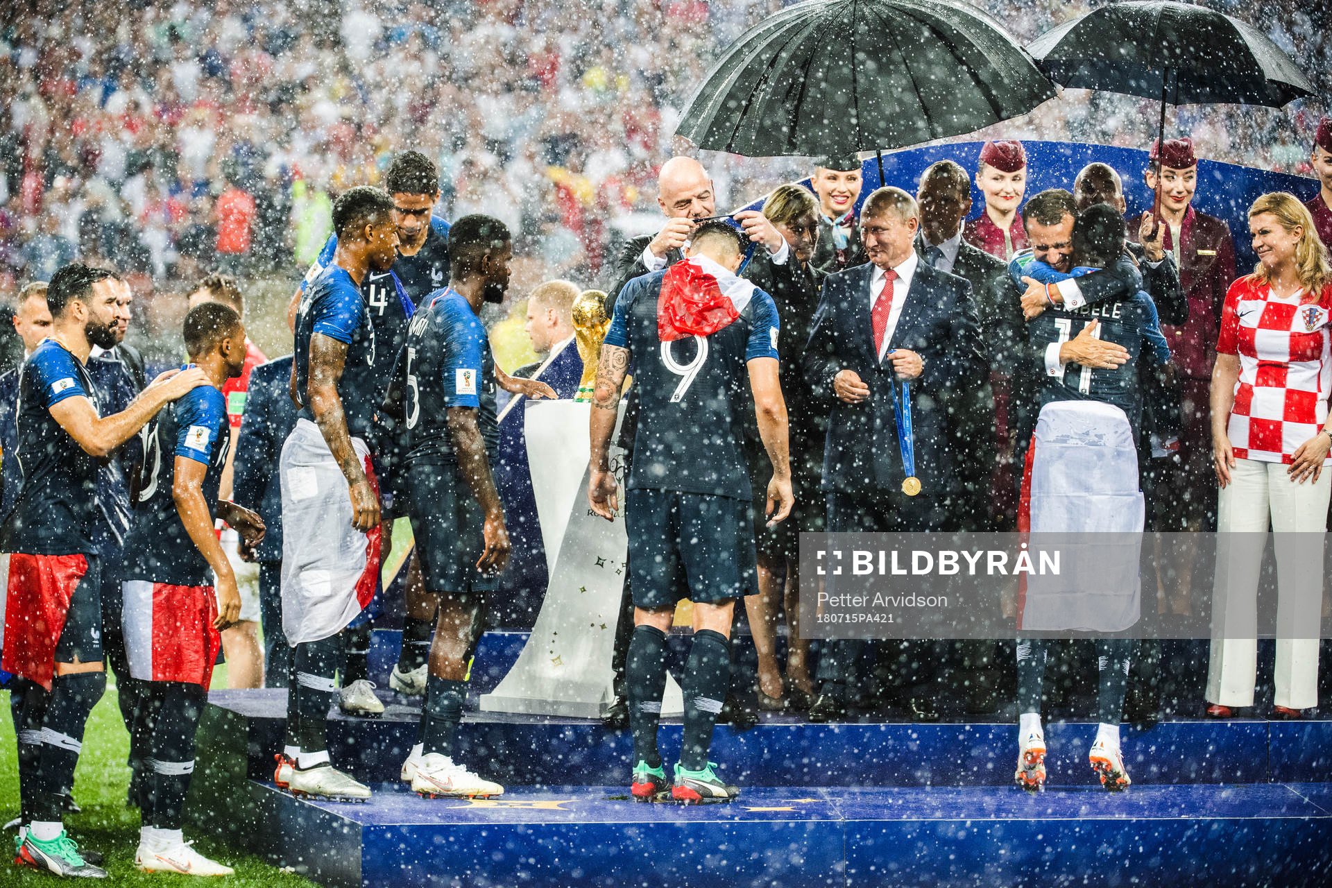 Olivier Giroud of France receives his gold medal from FIFA president Gianni Infantino, who together with the President of Russia Vladimir Putin, President of France Emmanuel Macron and President of Croatia Kolinda Grabar-Kitarovic are present on the podium during the medal ceremony after the FIFA World Cup final match between France and Croatia on July 15, 2018 in Moscow.