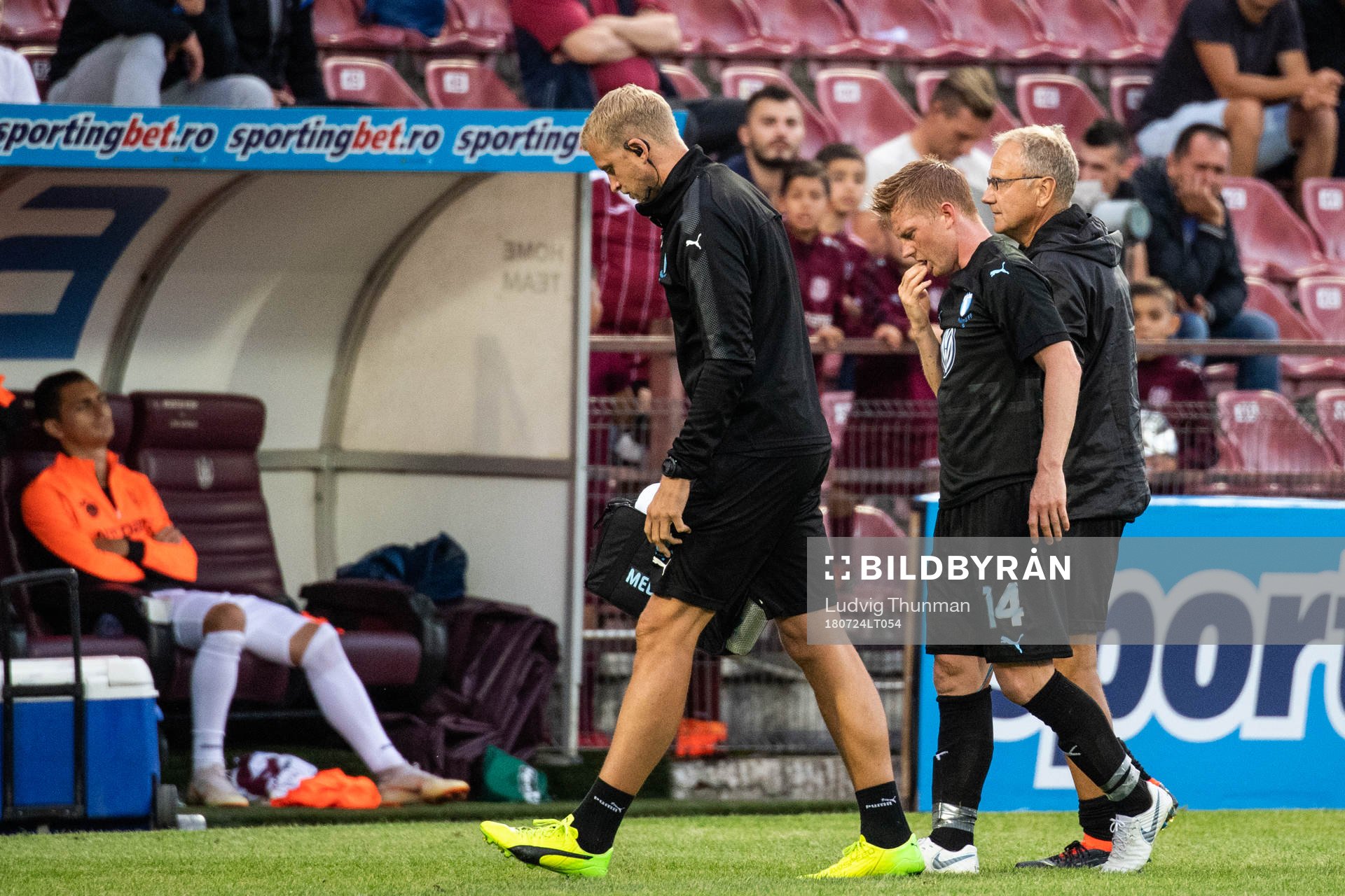 Anders Christiansen of Malmö FF is helped off the pitch by