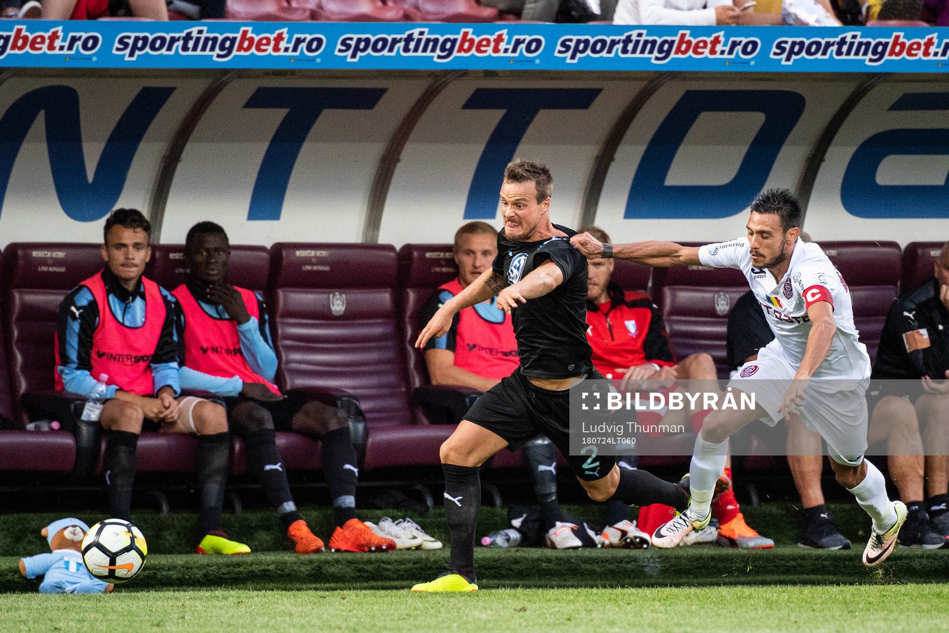 Camora of Cluj pulls the jersey of Eric Larsson of Malmö FF
