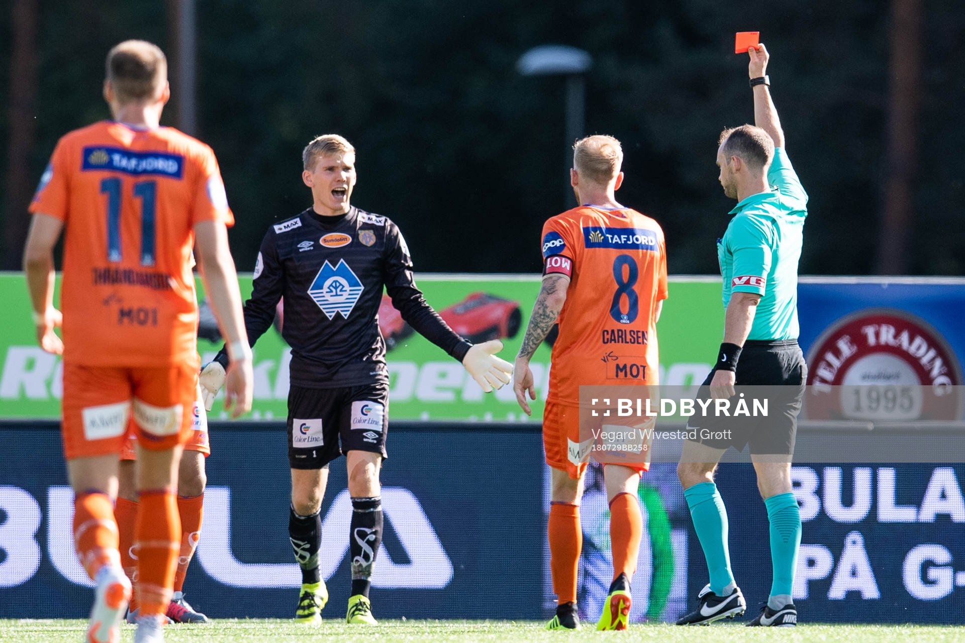 Referee Christian Moen gives a red card to a player of