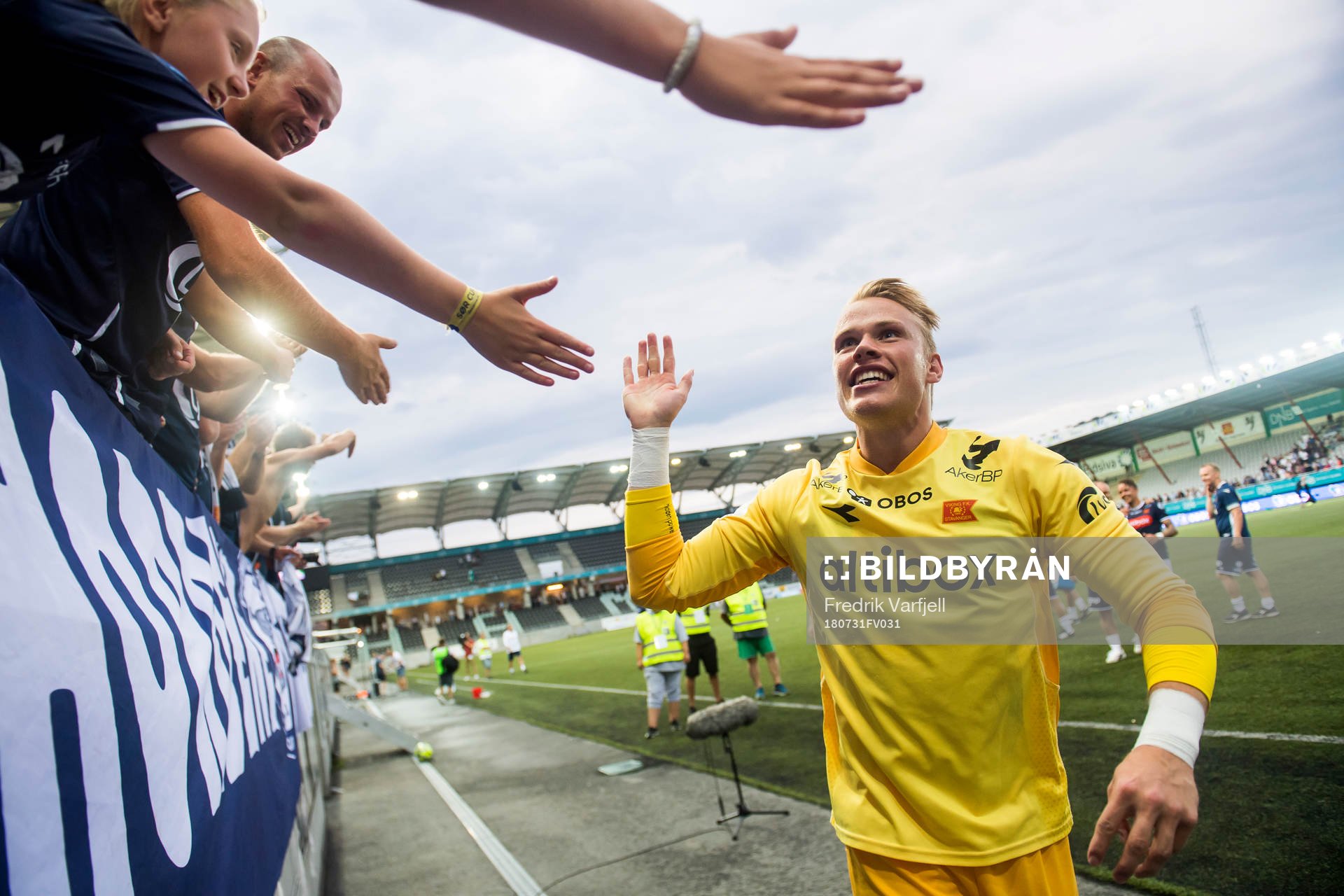 Goalkeeper Amund Wichne of Viking celebrates with the fans