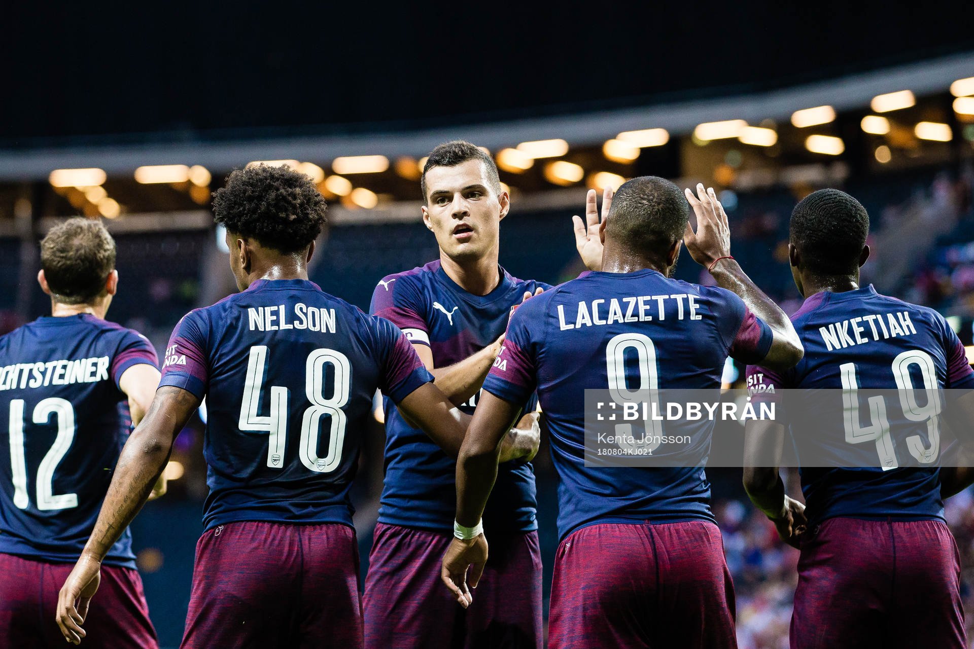 Granit Xhaka of Arsenal celebrates with Reiss Nelson of