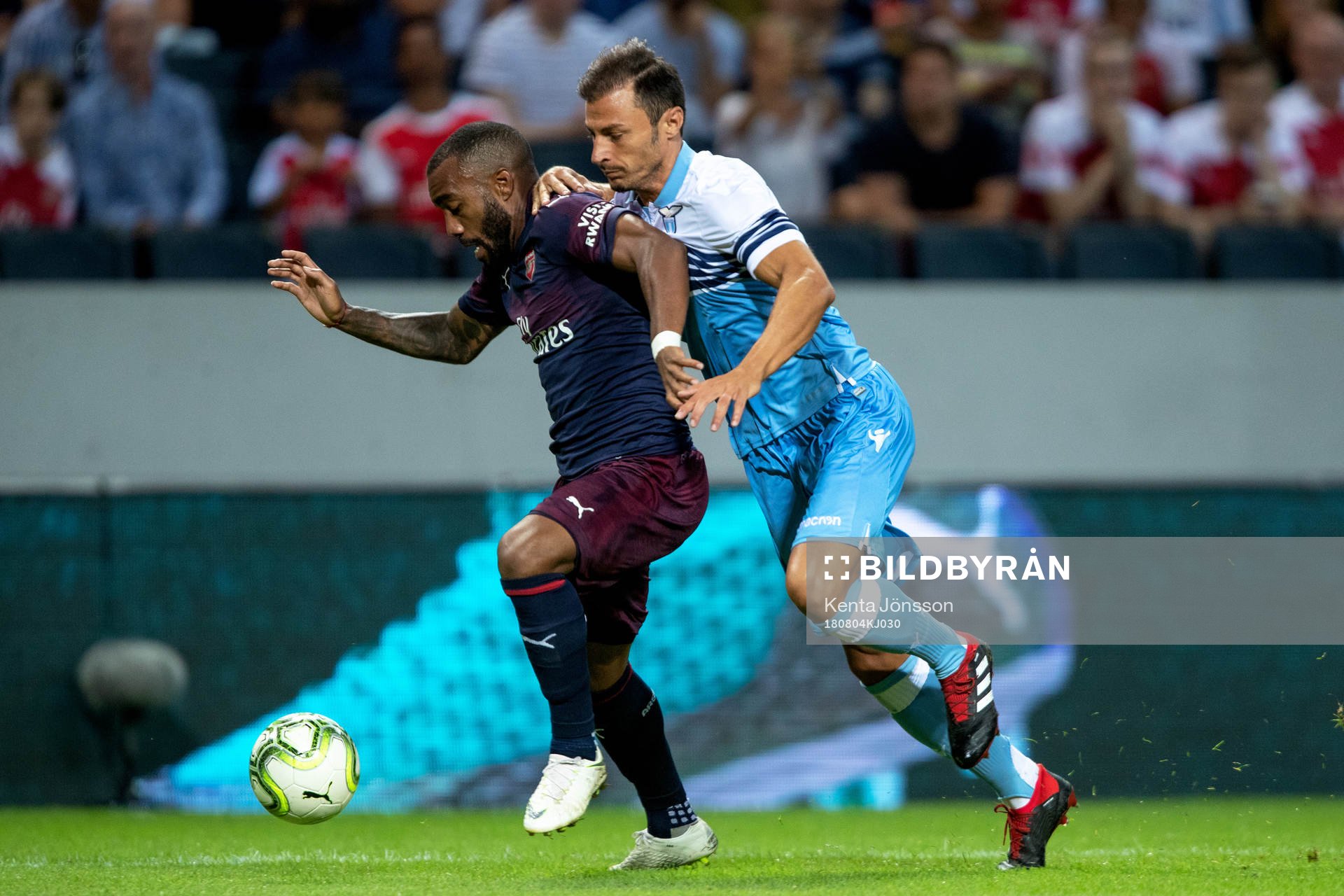Alexandre Lacazette of Arsenal and Stefan Radu of Lazio
