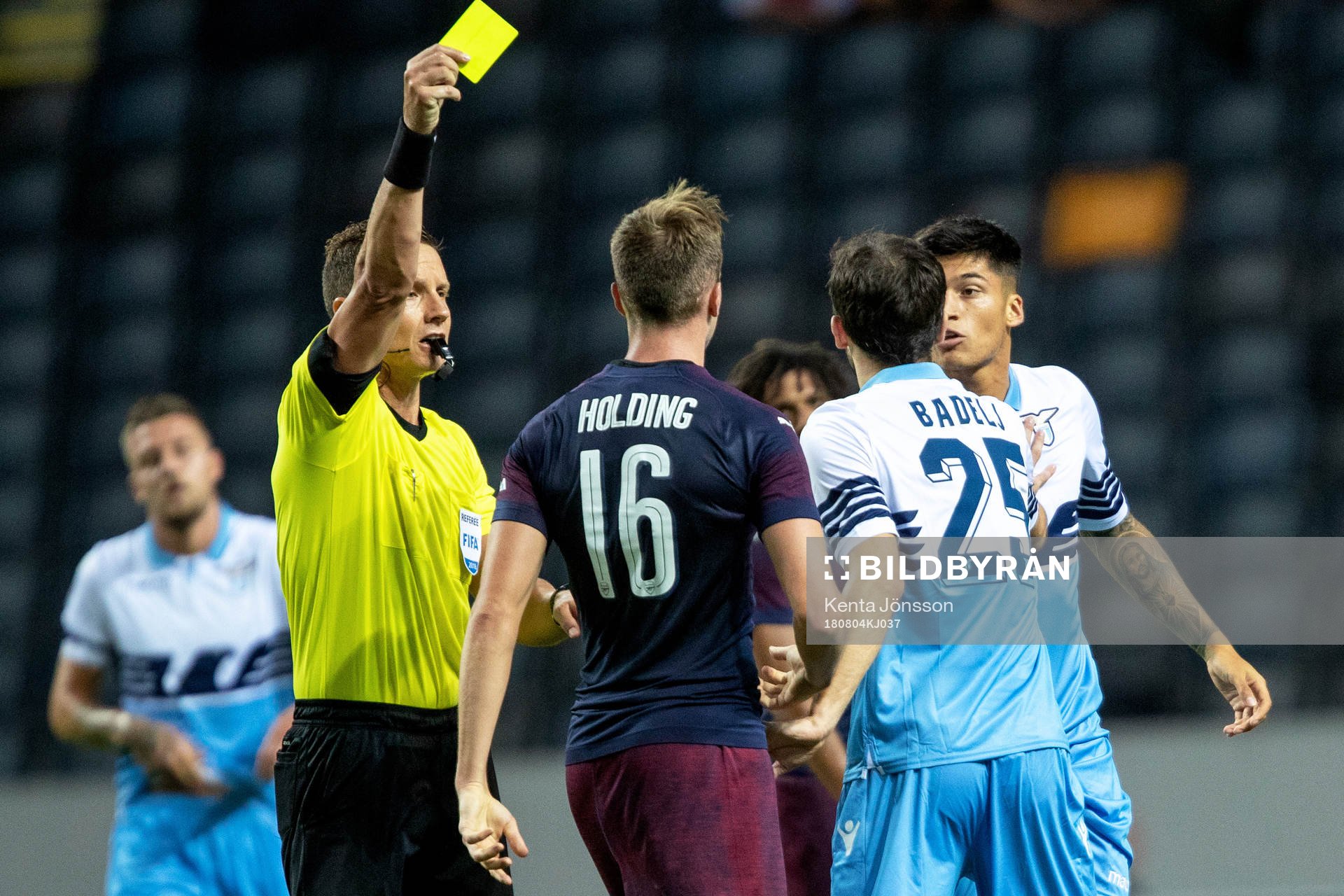 Rob Holding of Arsenal gets a yellow card from referee