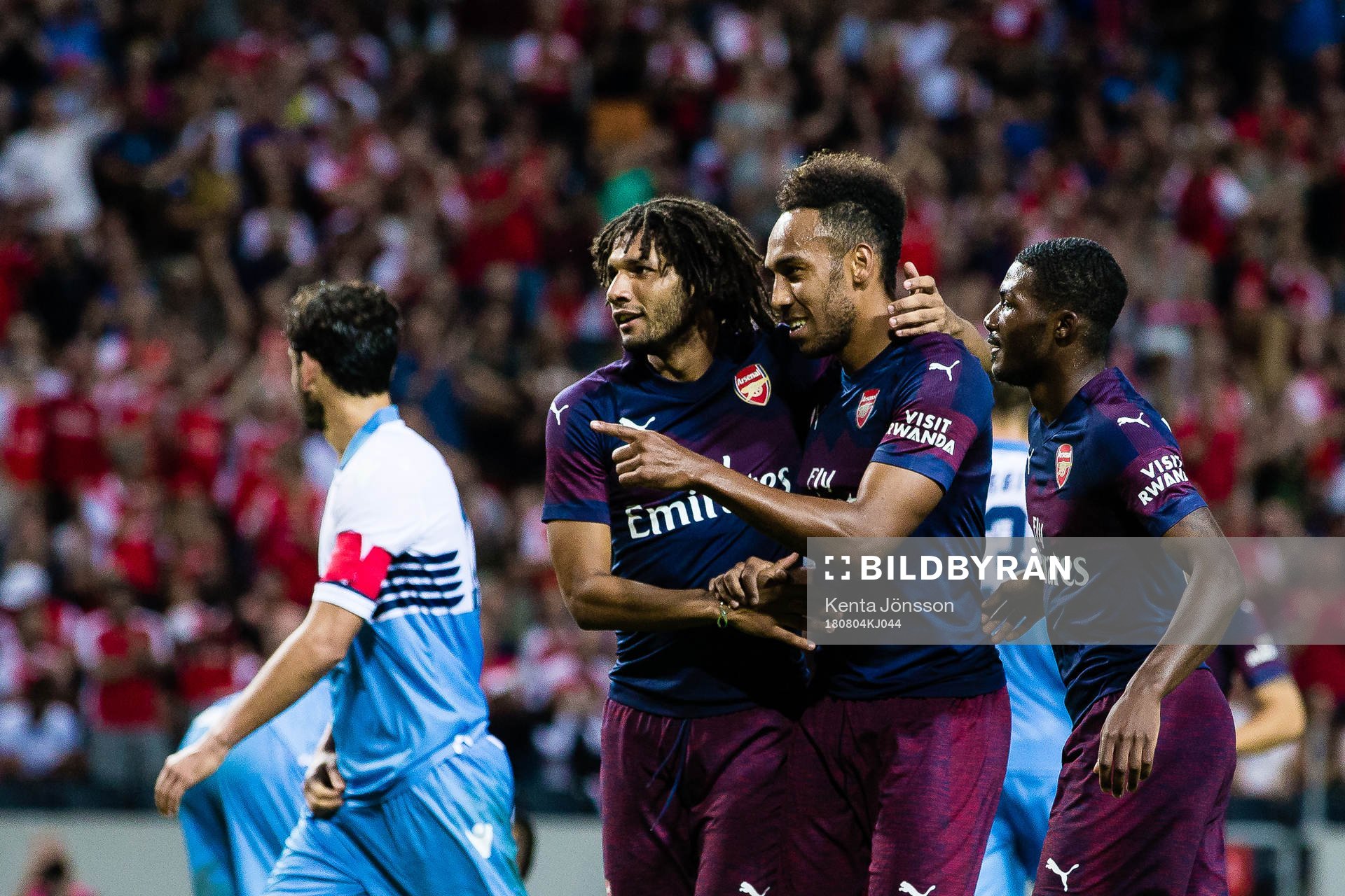 Pierre-Emerick Aubameyang of Arsenal celebrates with teammates Mohamed Elneny and Ainsley Maitland-Niles after 2-0 during the International Champions Cup match between Arsenal and Lazio on August 4, 2018 in Stockholm.