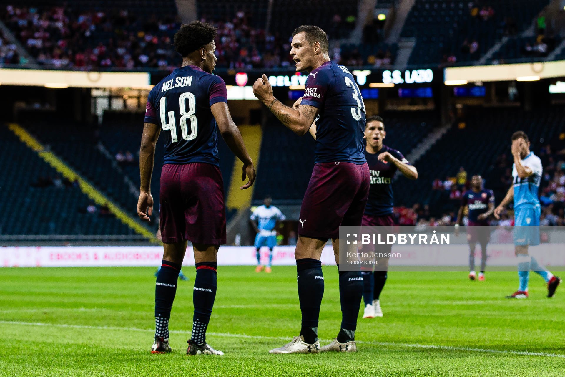 Reiss Nelson of Arsenal and Granit Xhaka of Arsenal