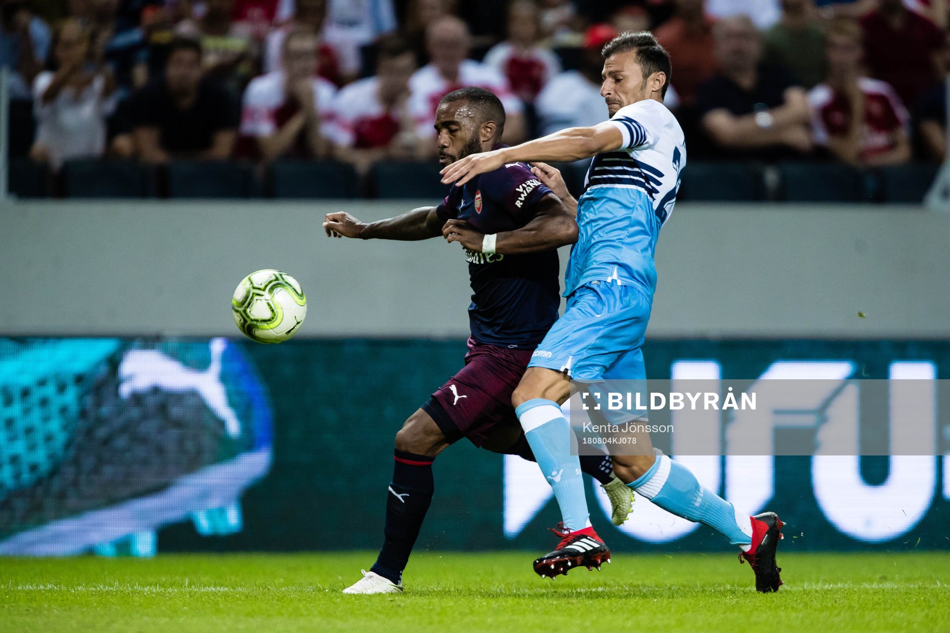 Alexandre Lacazette of Arsenal and Stefan Radu of Lazio