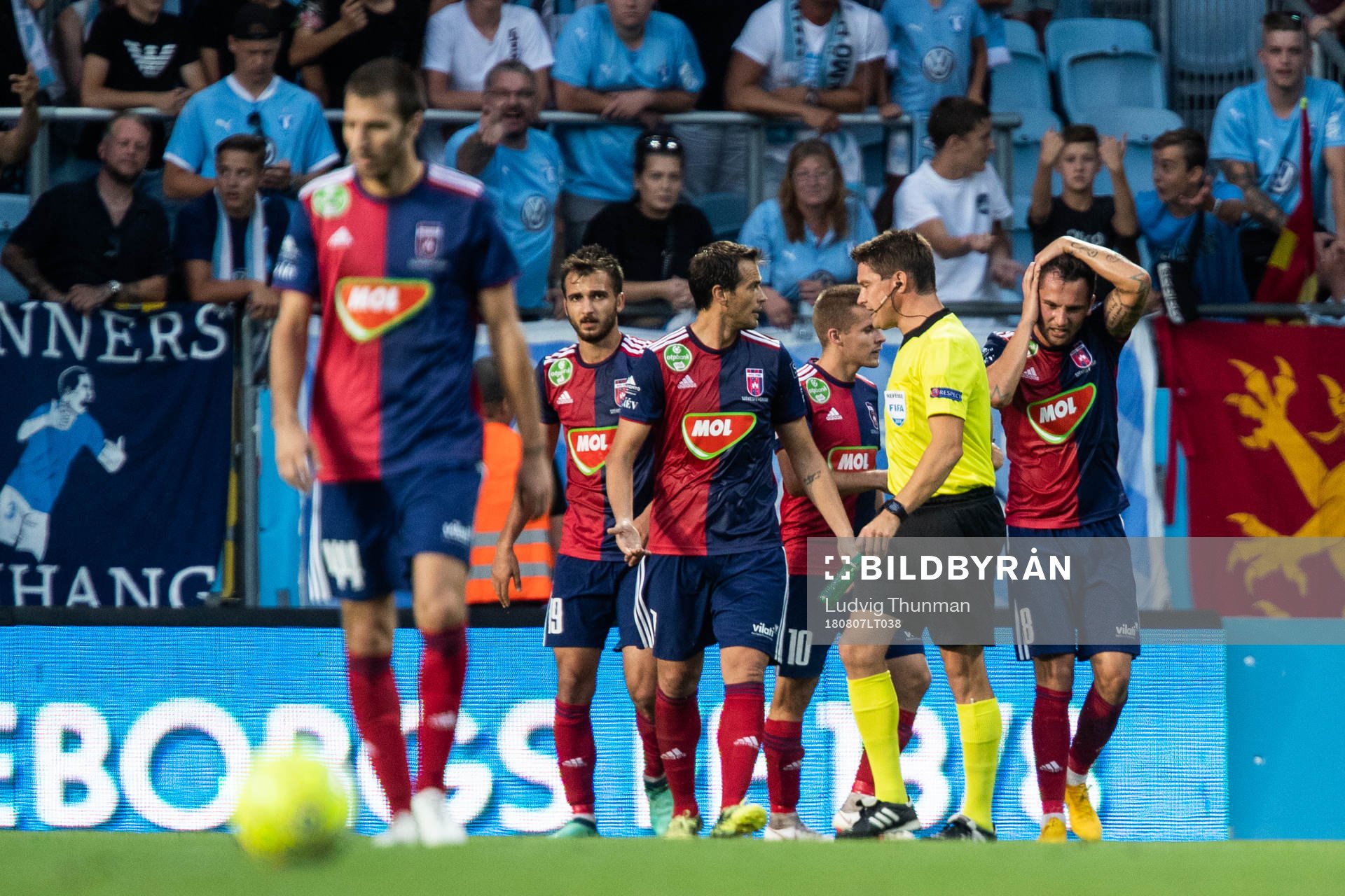 The referee holds a bottle which hit Anel Hadžić of